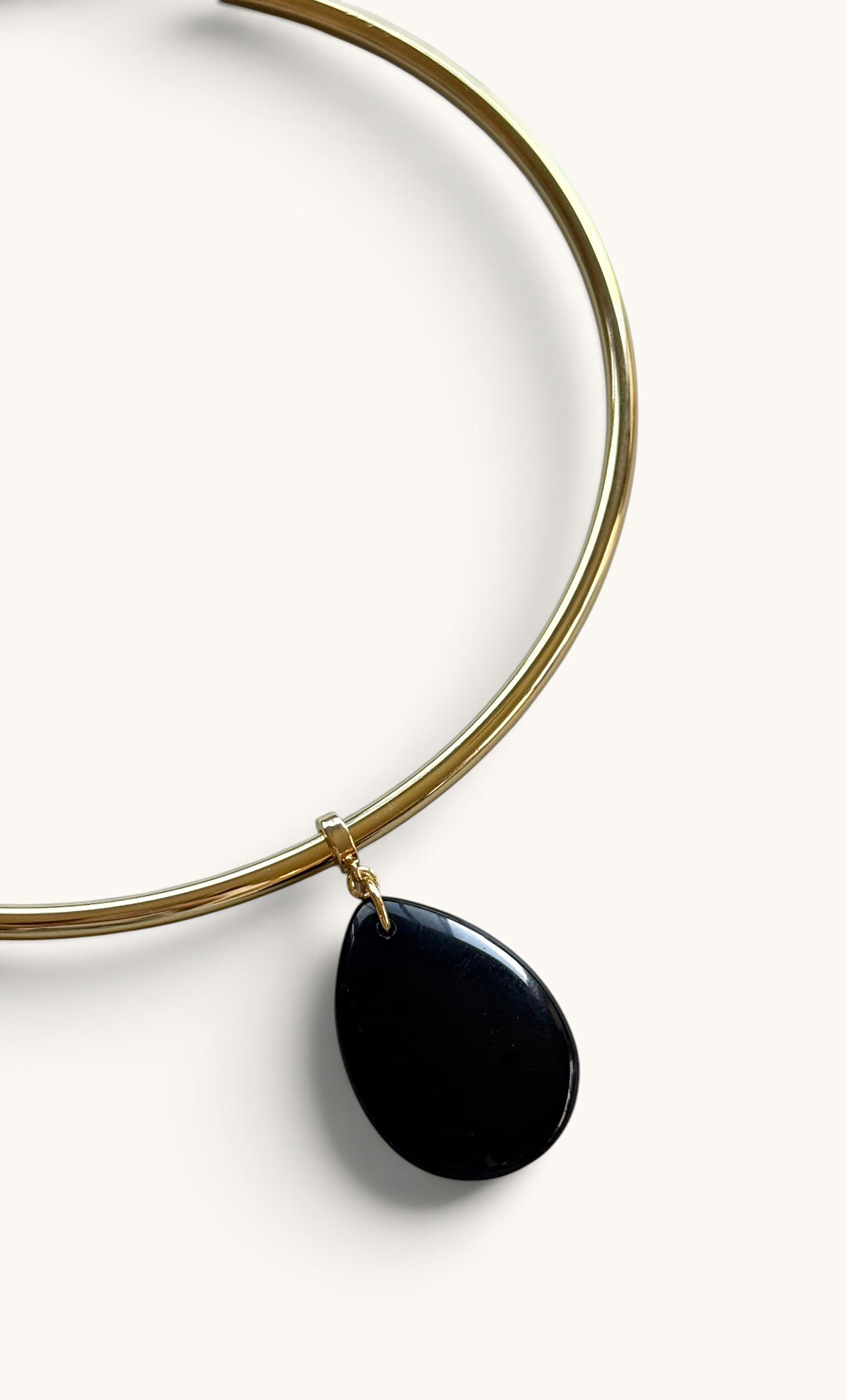 Gold fill collar necklace with a smooth black agate teardrop pendant from Tunik.