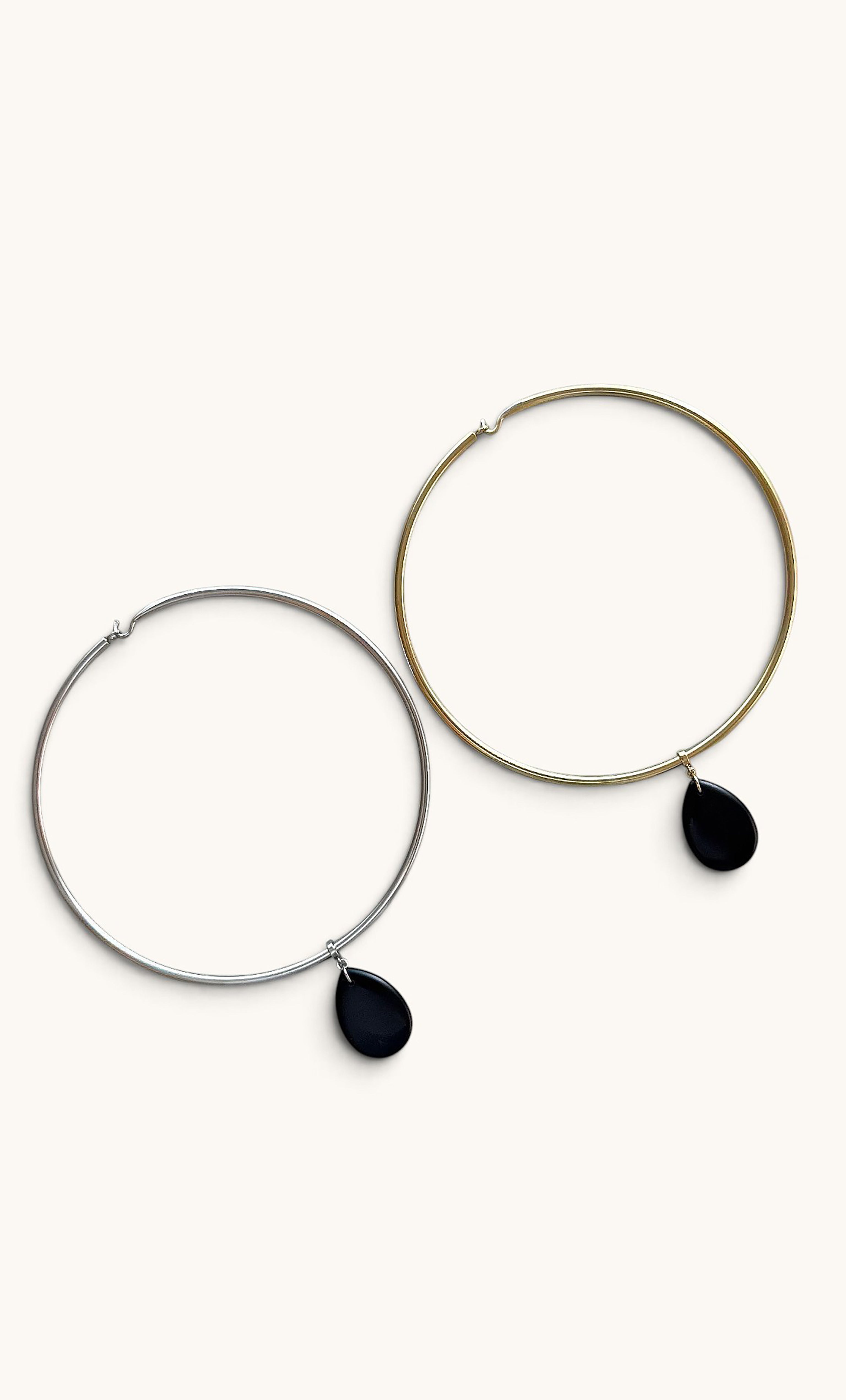 Two large hoop collar necklaces in gold fill and silver, each with a black agate stone drop pendant.