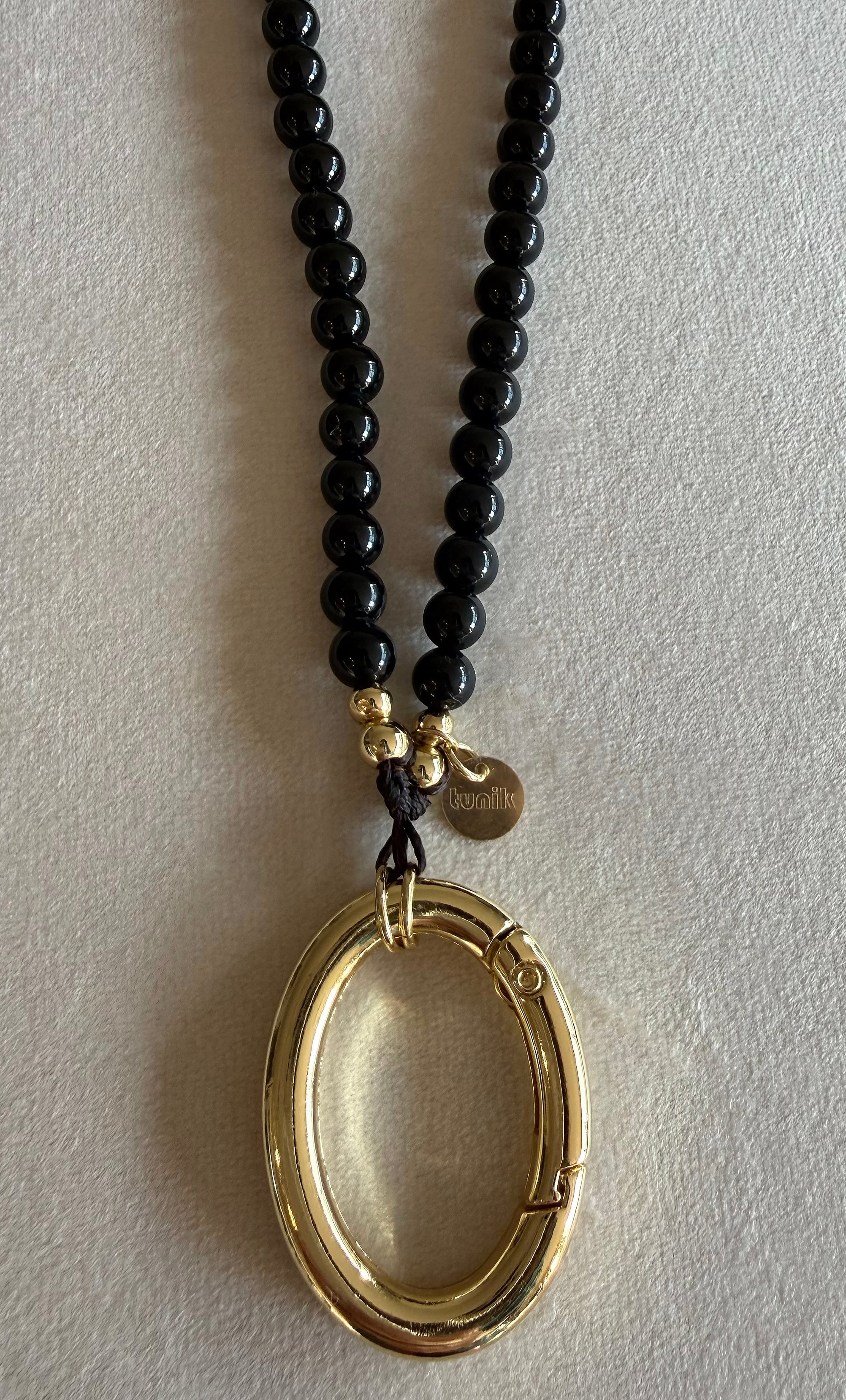 Tunik jewellery gold fill necklace with black agate stone beads and large oval gold pendant.