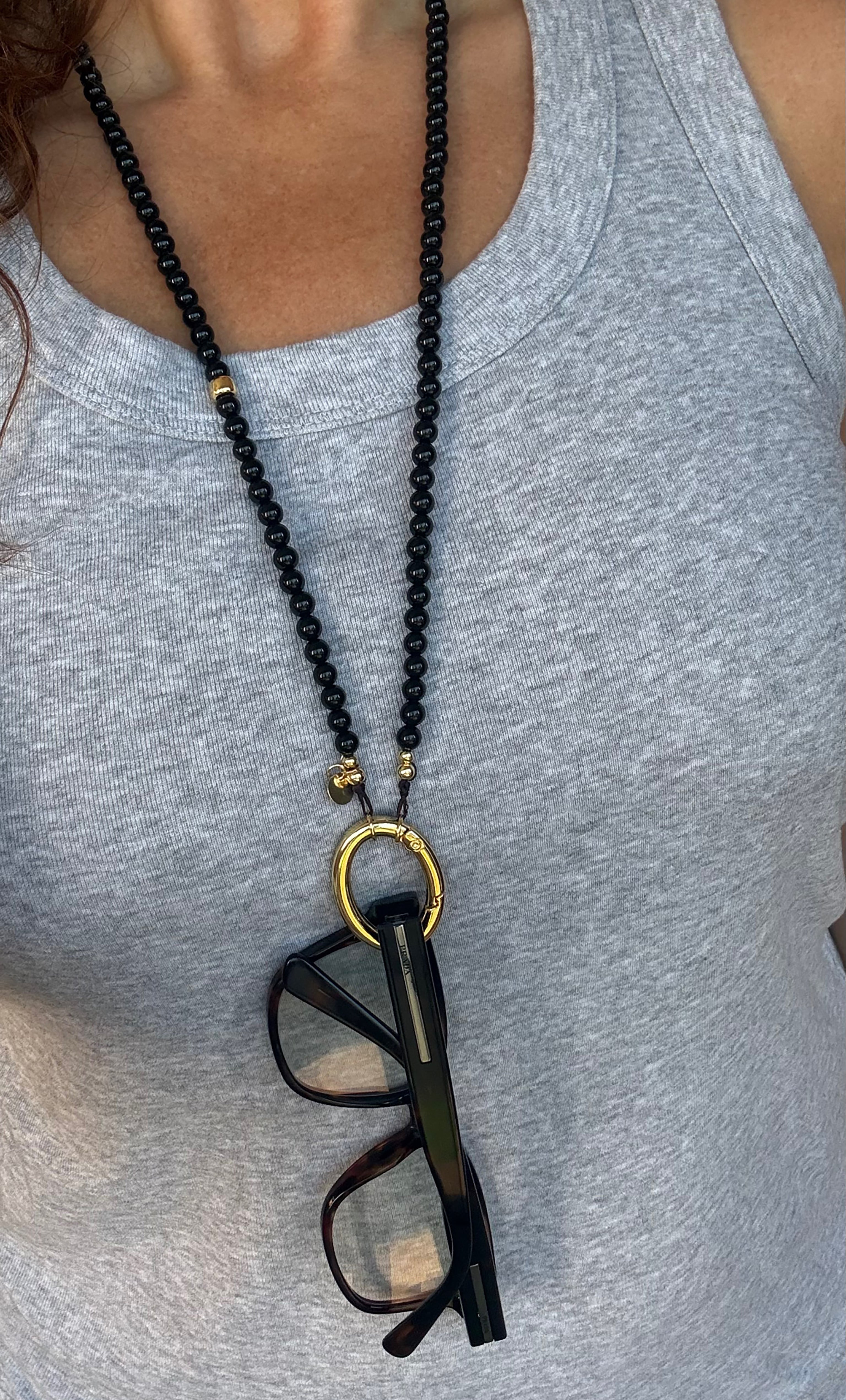 Tunik jewellery black beaded lanyard necklace with 14K gold fill ring holding black eyeglasses, jewellery gifts.