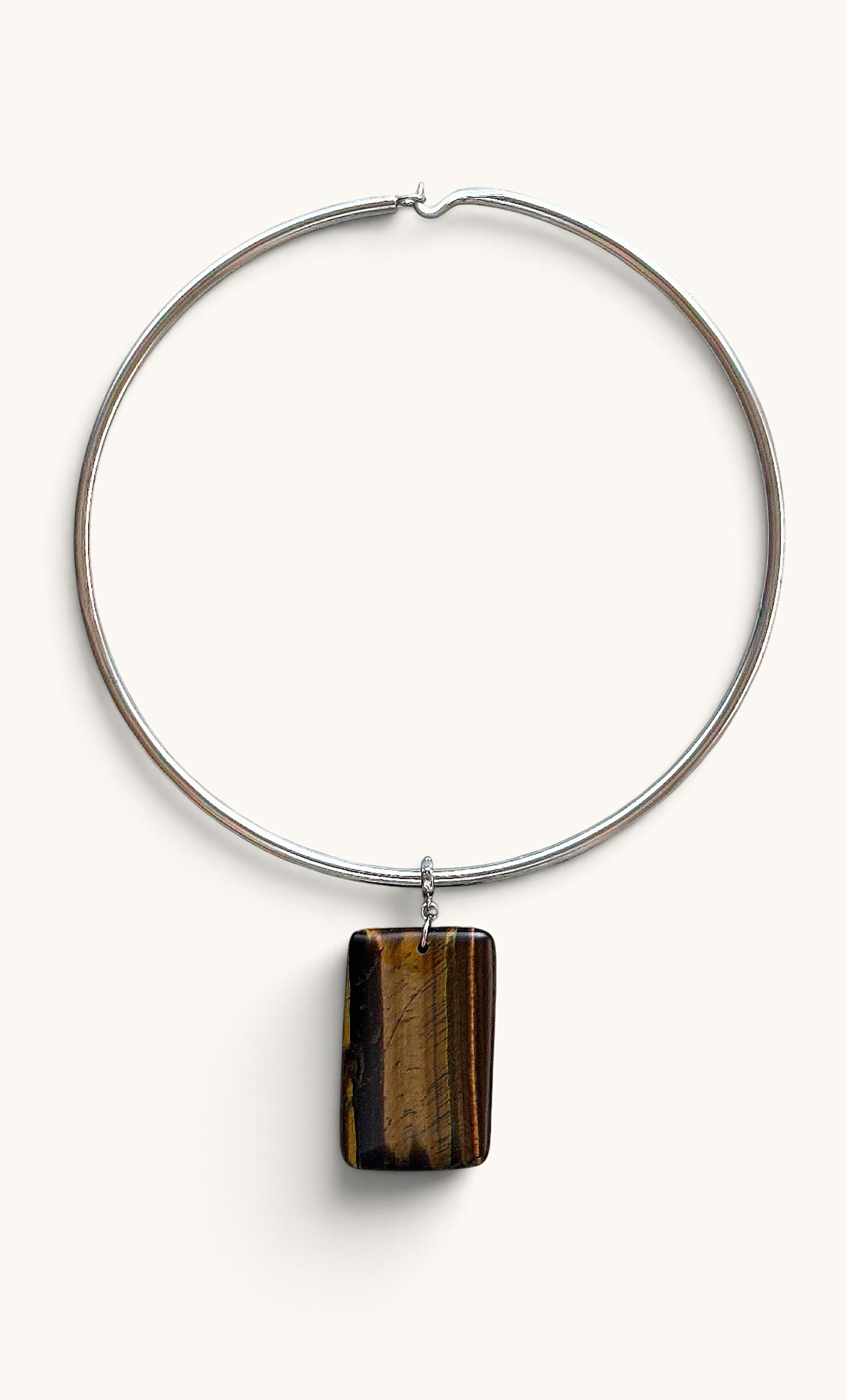 Silver collar necklace with rectangular polished tiger’s eye pendant by Tunik.