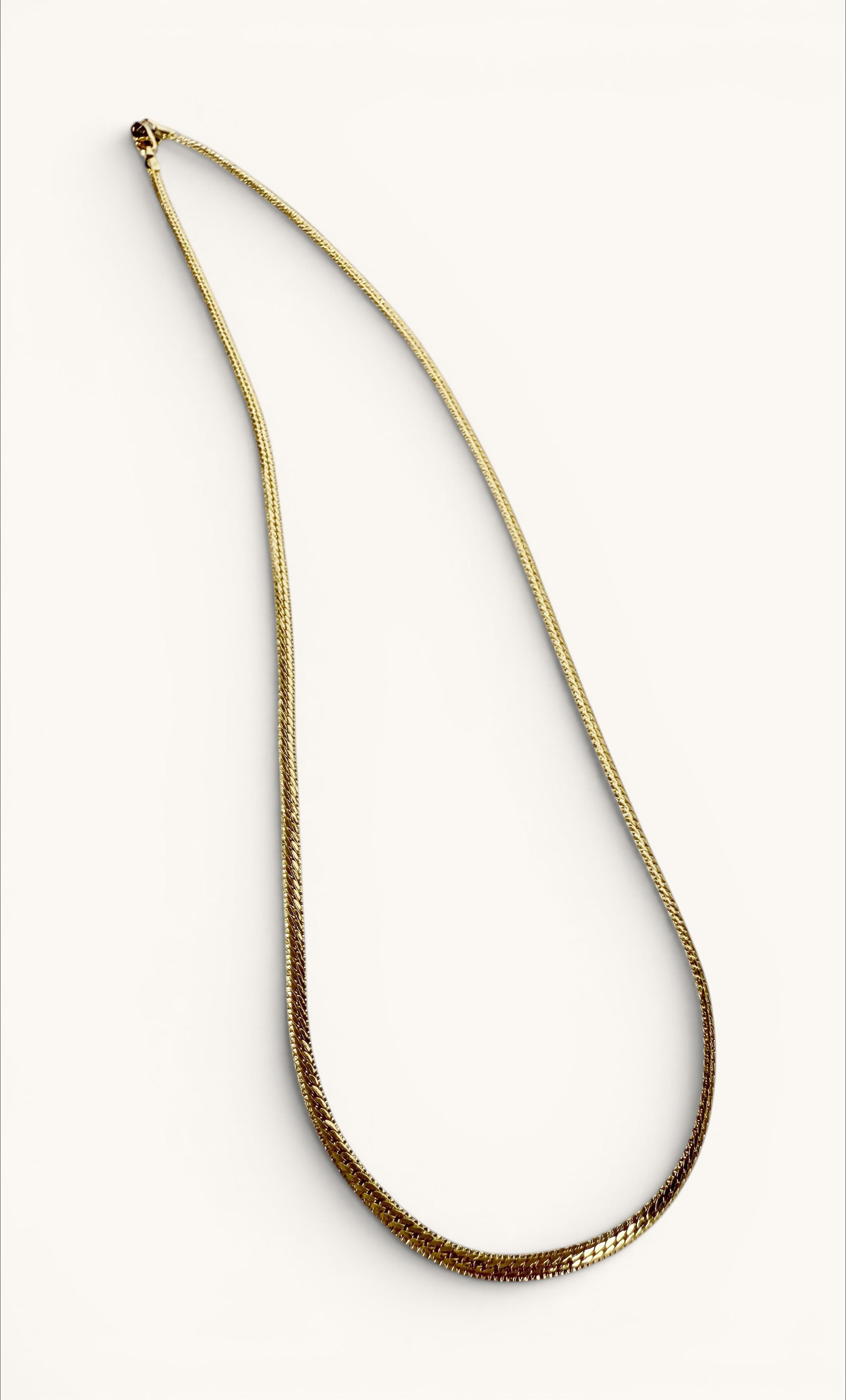 24K gold fill herringbone chain necklace with smooth, flat links and a polished finish.