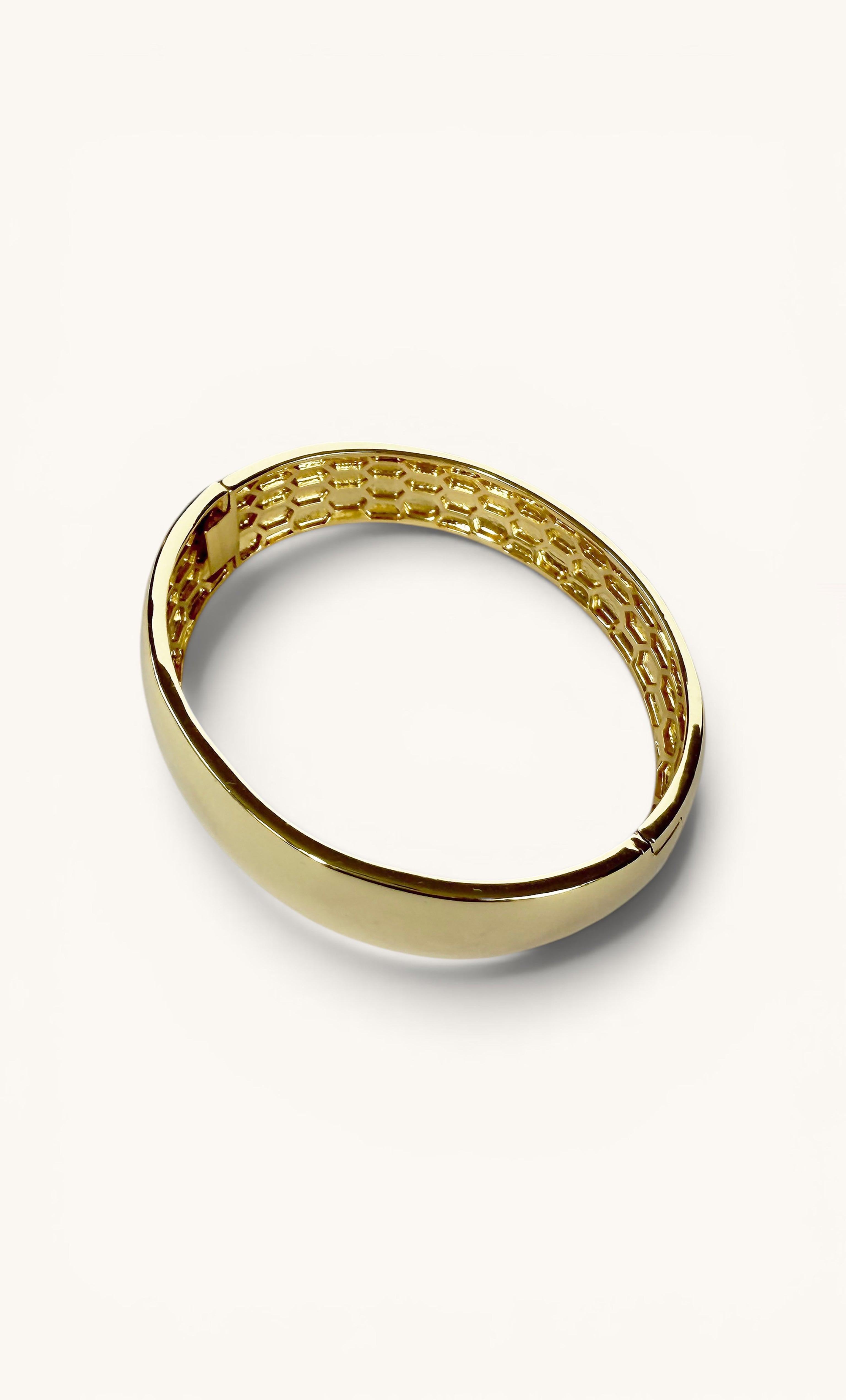 Smooth polished 24K gold fill bangle with a rounded cuff shape and subtle inner texture.