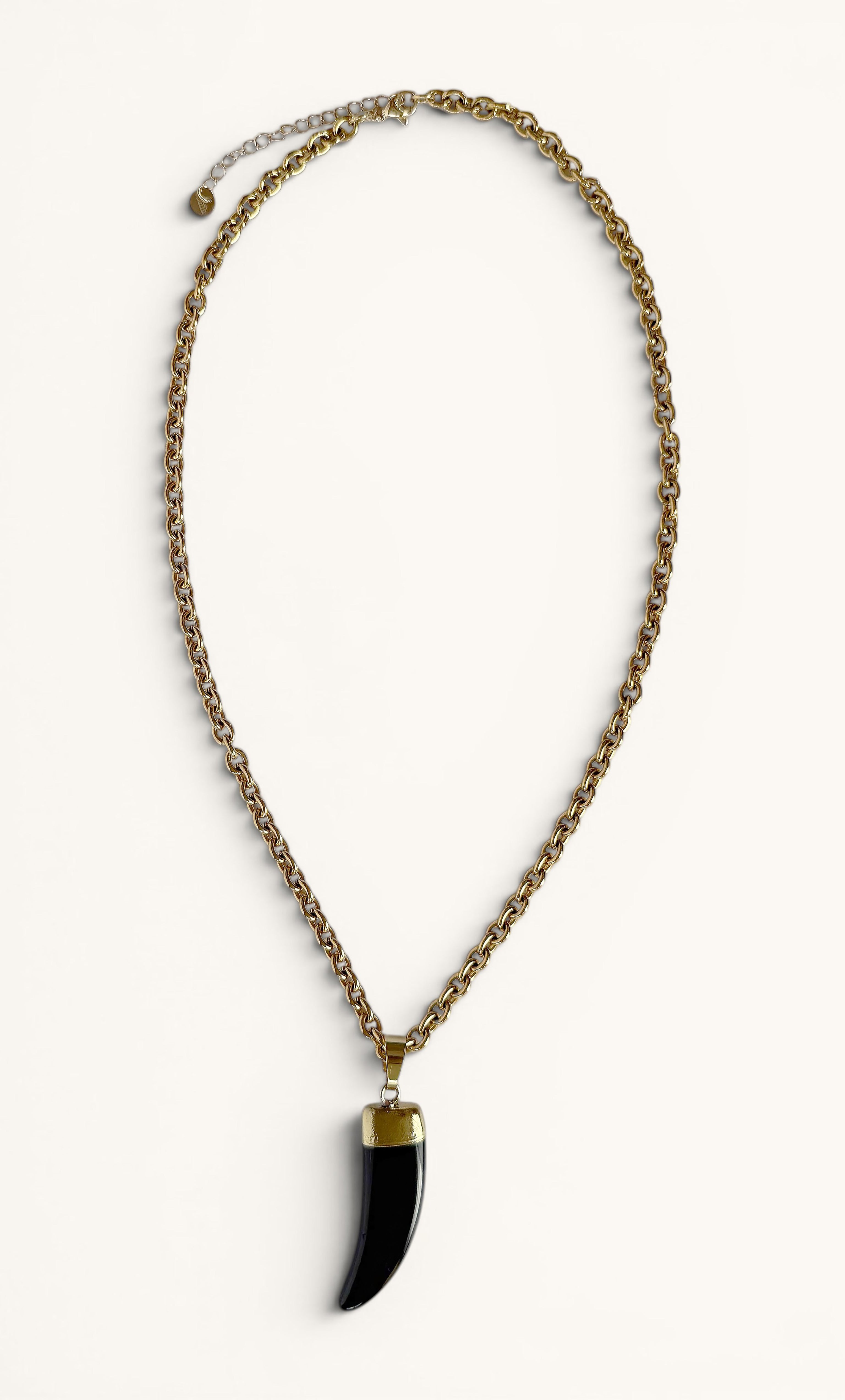 Gold fill chain necklace with a carved black agate horn pendant by Tunik.