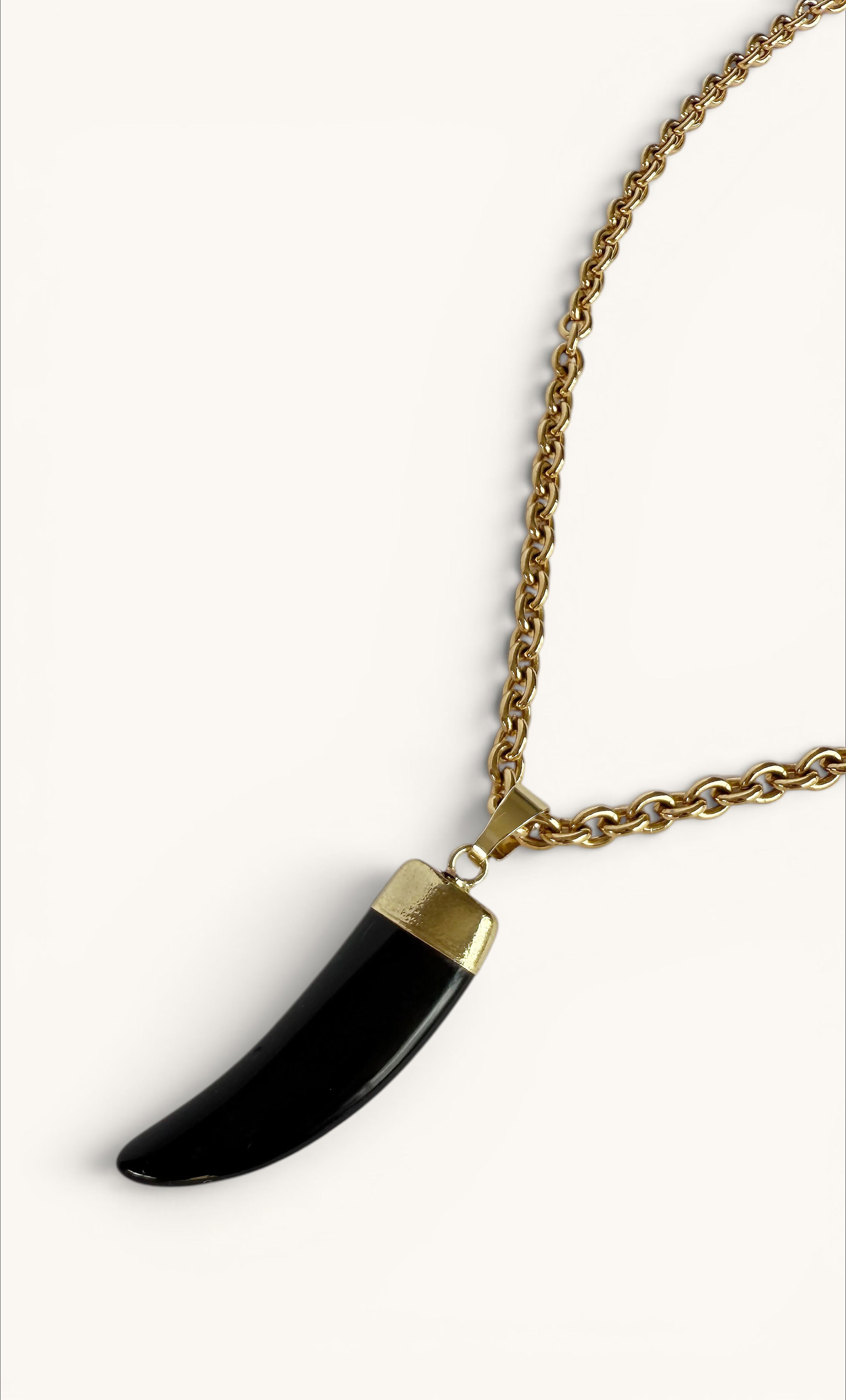 Long gold fill chain necklace with a smooth black carved agate horn pendant and polished gold cap.