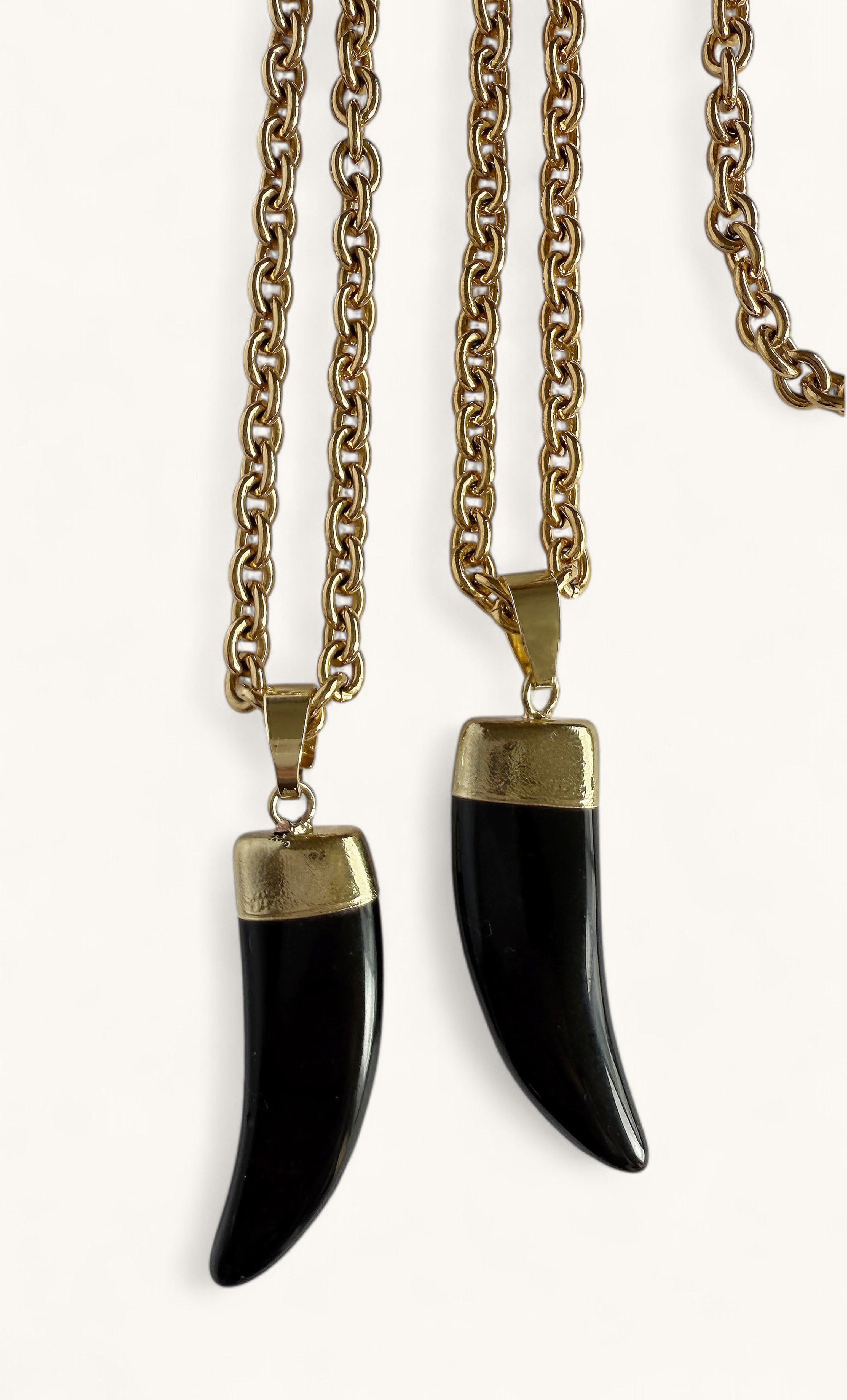 Two carved black agate horn pendants with 24K gold fill caps on gold fill chains, one long and one short length.