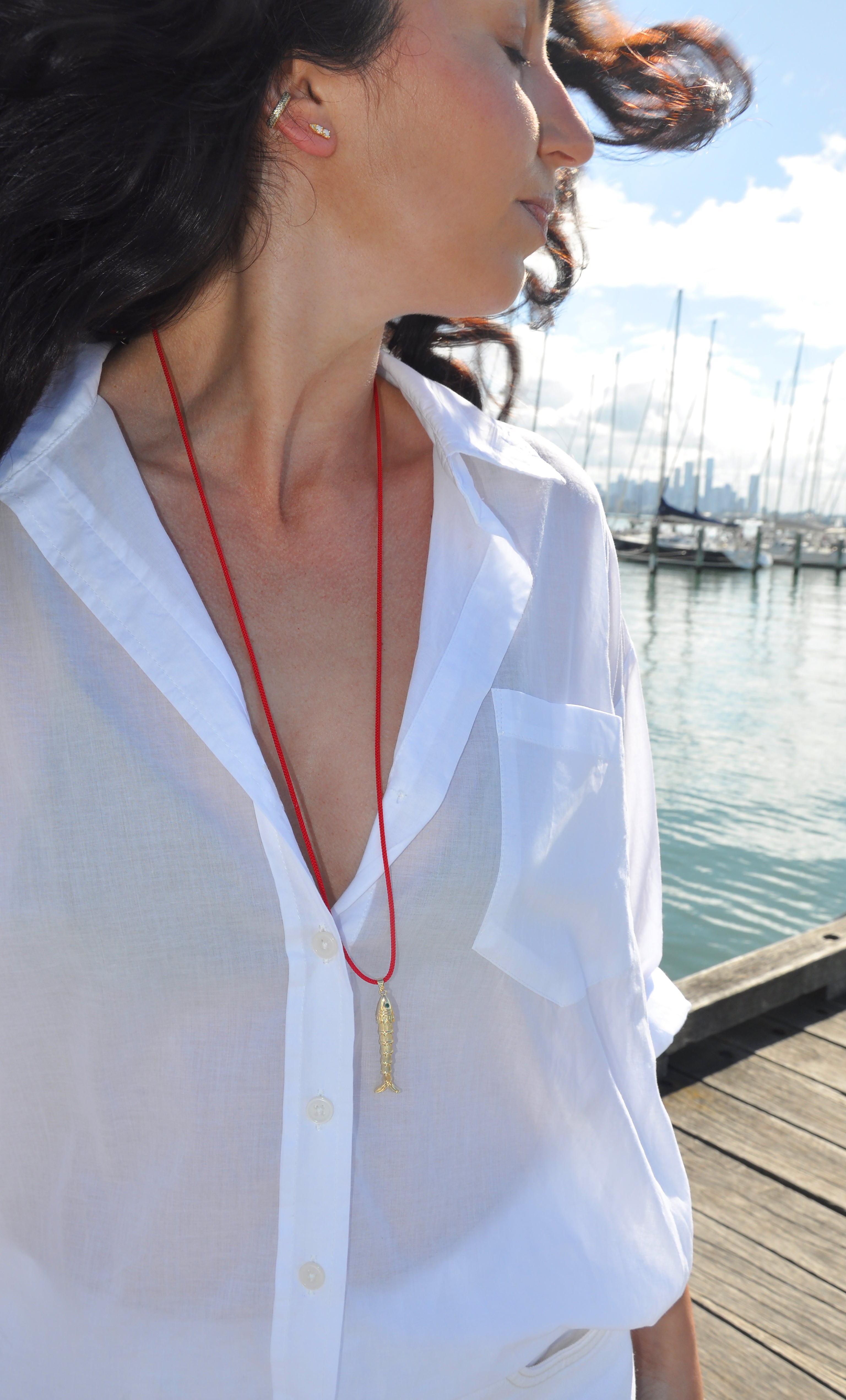 Tunik gold-fill koi fish pendant necklace on red Japanese cord, styled with white shirt near marina, jewellery gifts.
