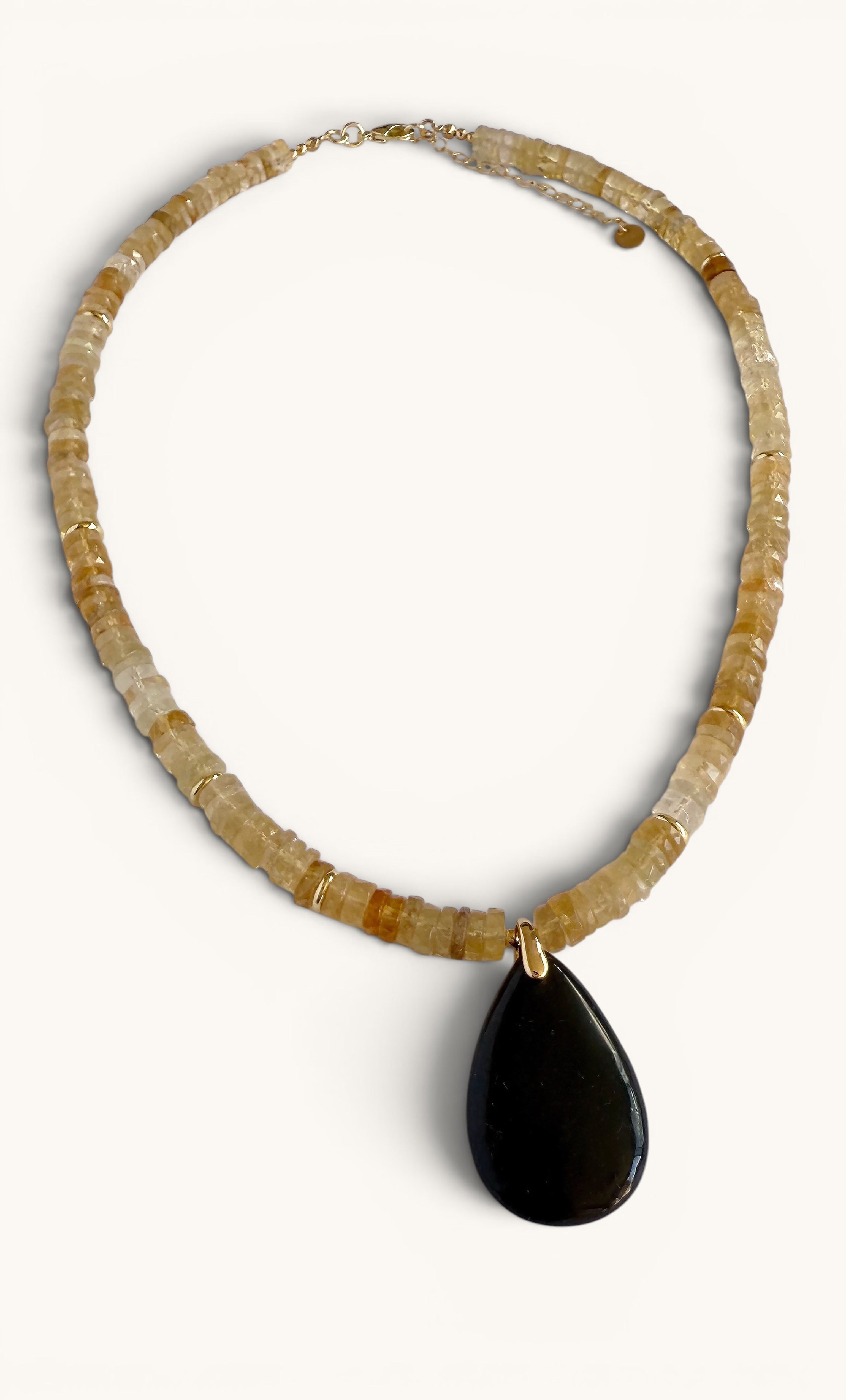 Gold-filled heishi bead necklace with natural citrine beads and a polished black shungite teardrop pendant.