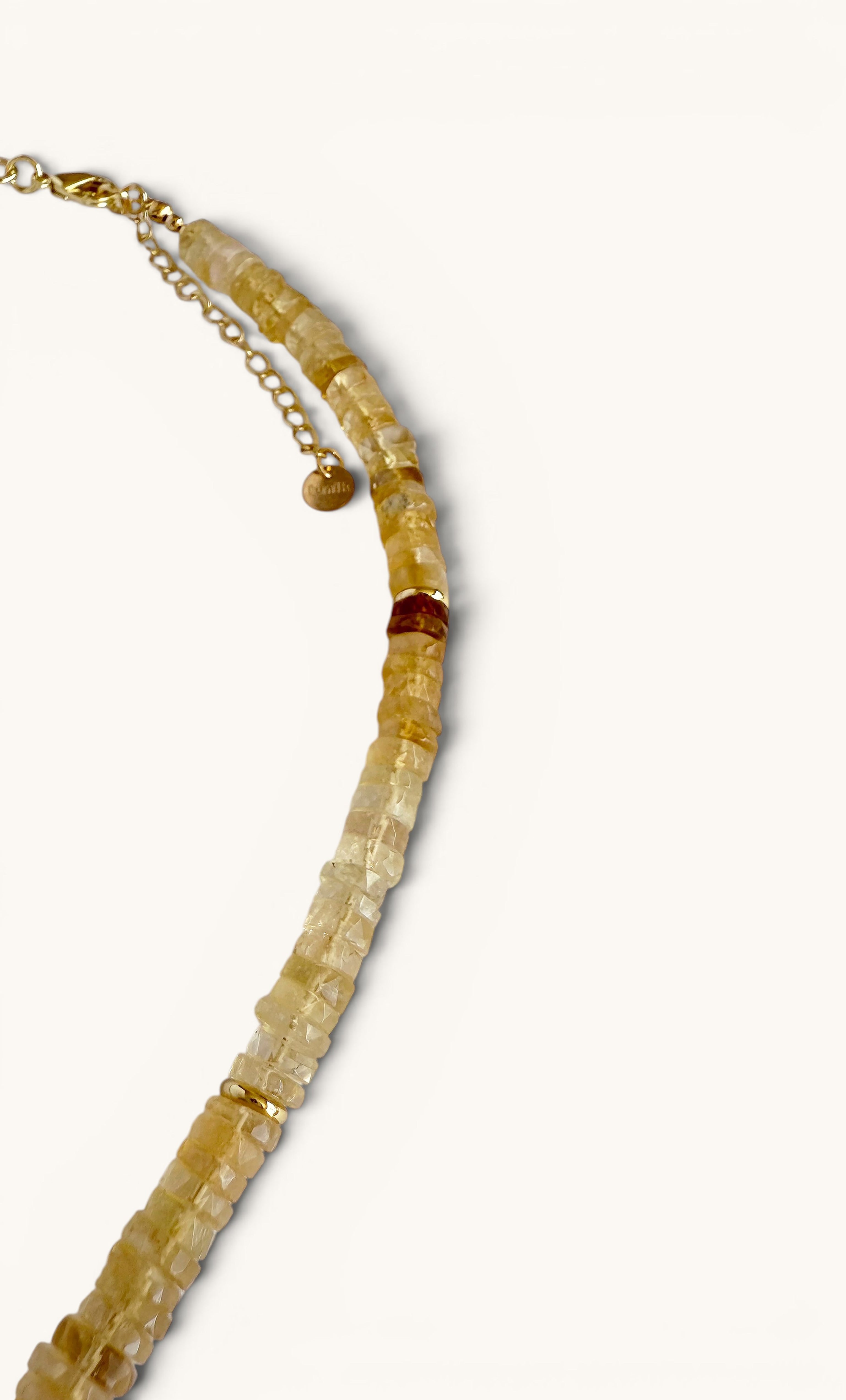 Gold fill heishi bead necklace with natural citrine beads and a black shungite carved pendant by Tunik.