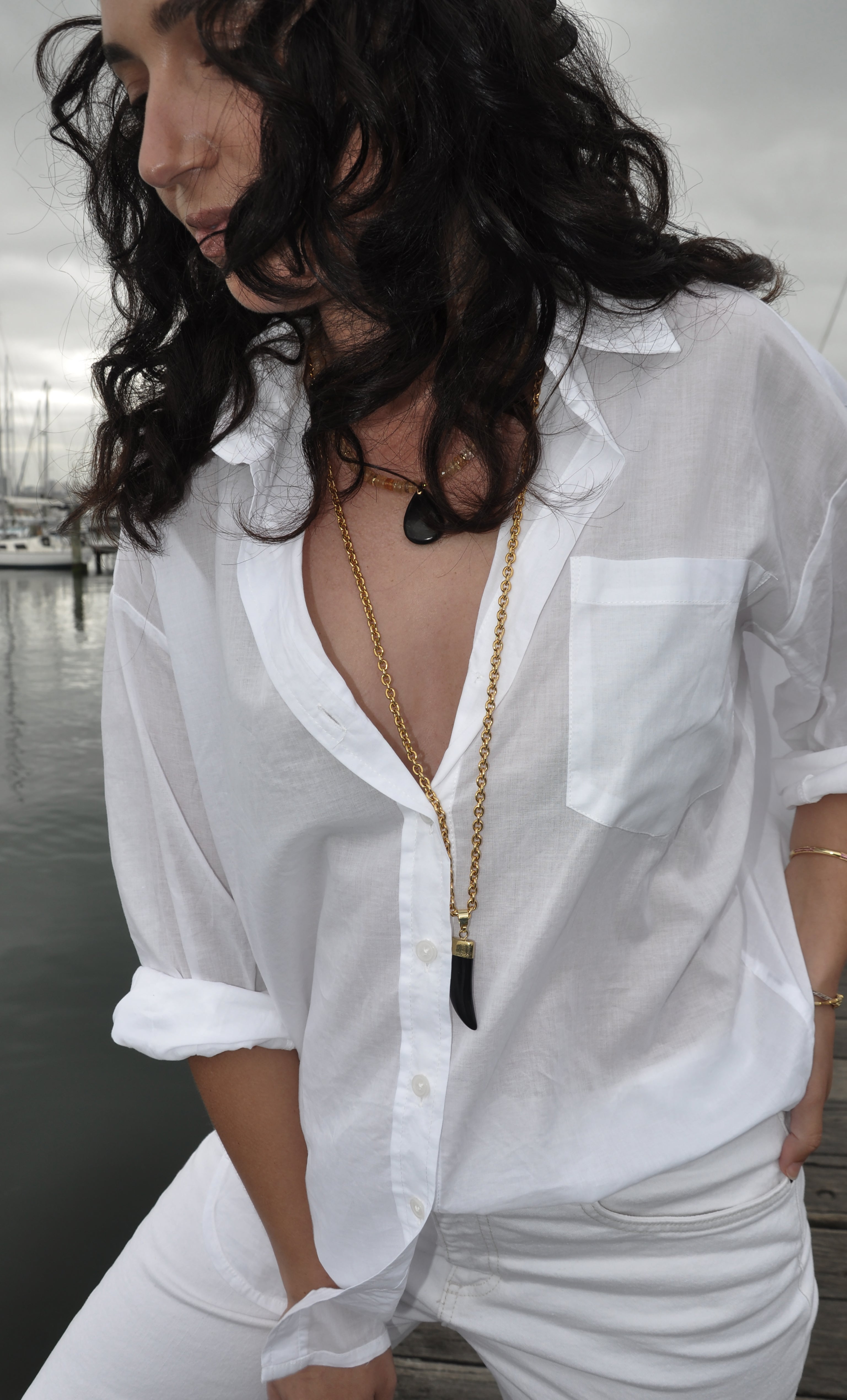 Tunik gold fill necklace with carved agate horn pendant layered over white shirt jewelry gifts.