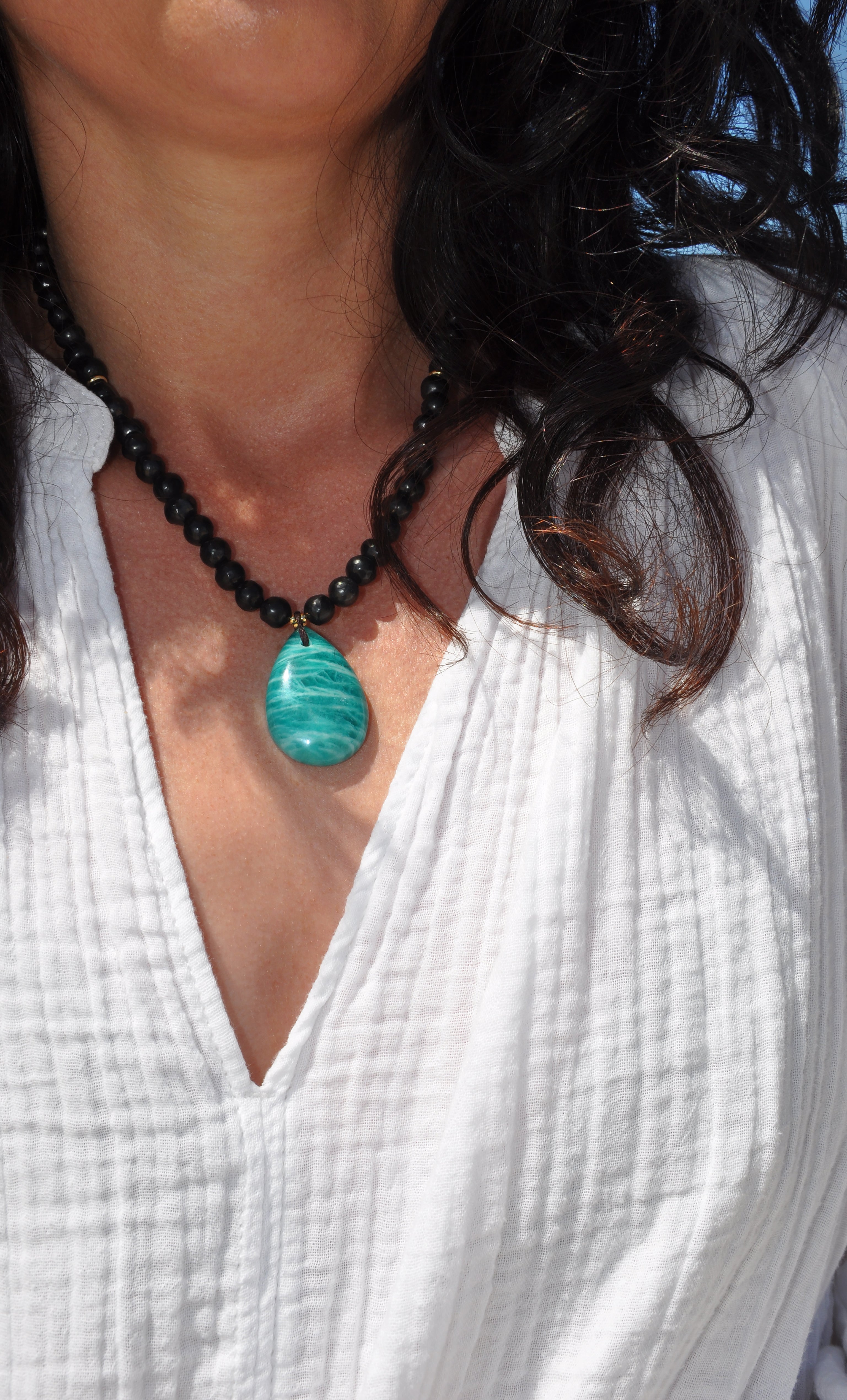 Gold fill Tunik necklace with natural black shungite pebble beads and vibrant amazonite pendant.