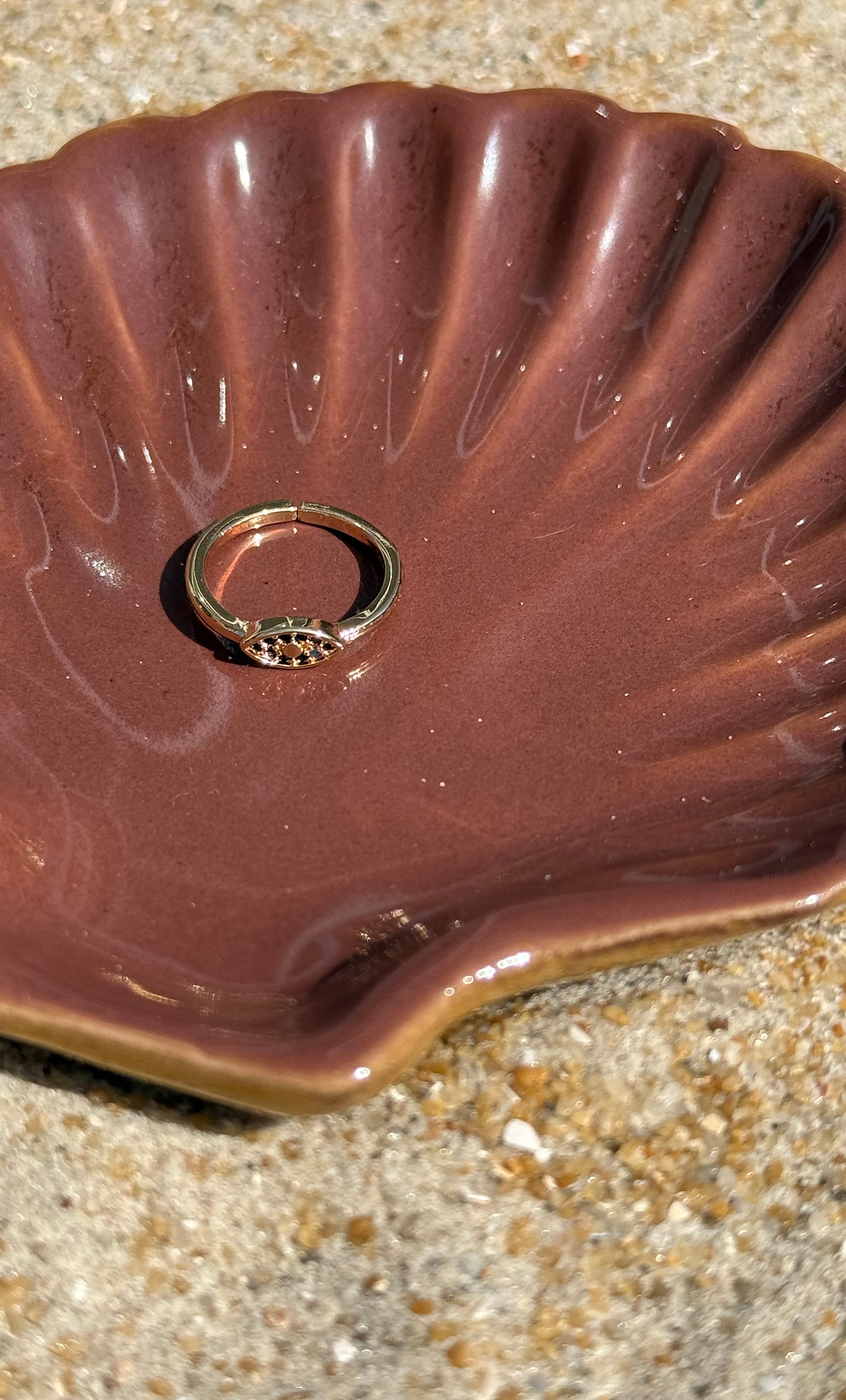 Tunik gold fill adjustable toe ring with black cubic zirconia stones resting in brown shell jewelry gift.
