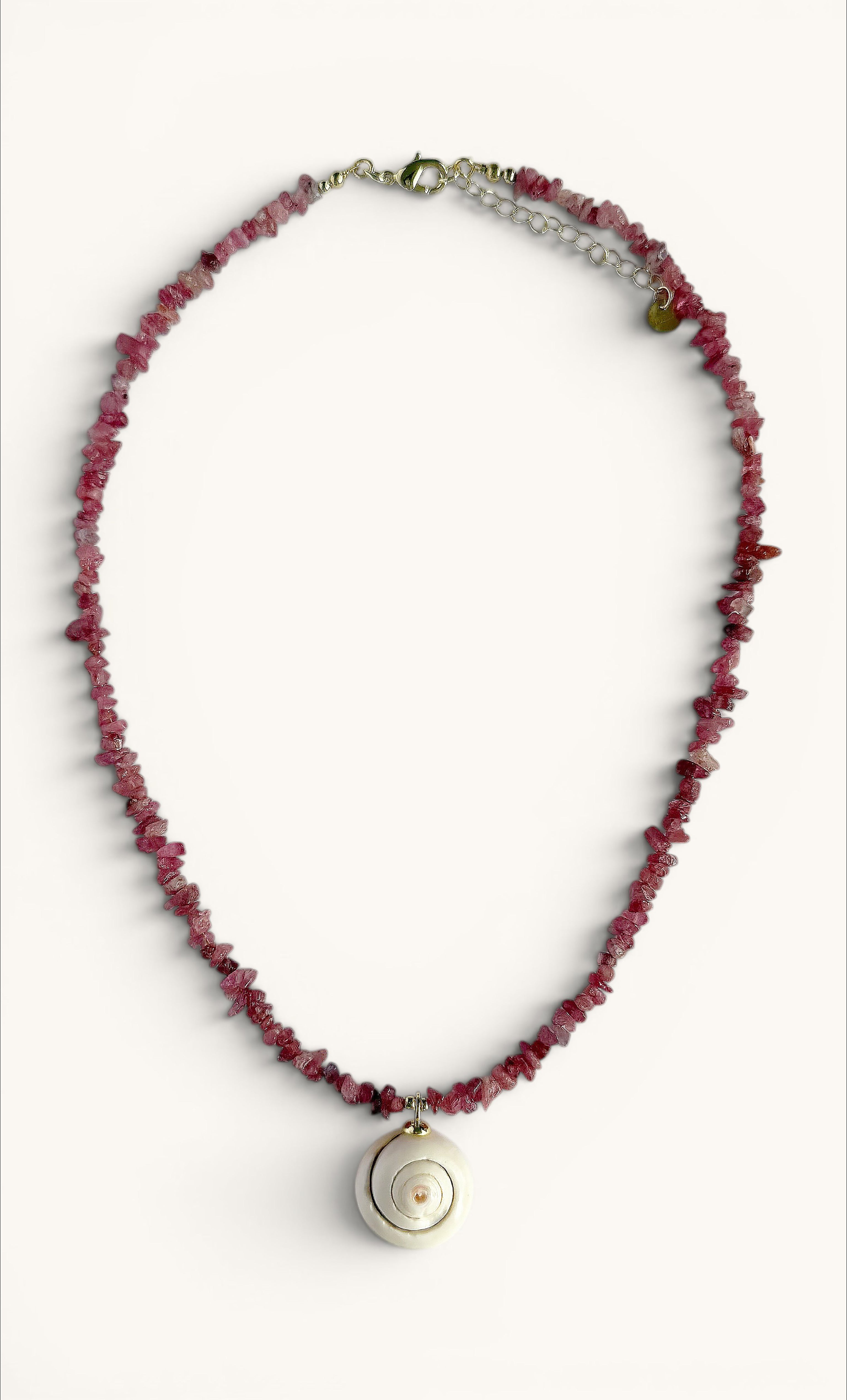 Gold-filled necklace with irregular pink tourmaline beads and a round shell charm pendant.