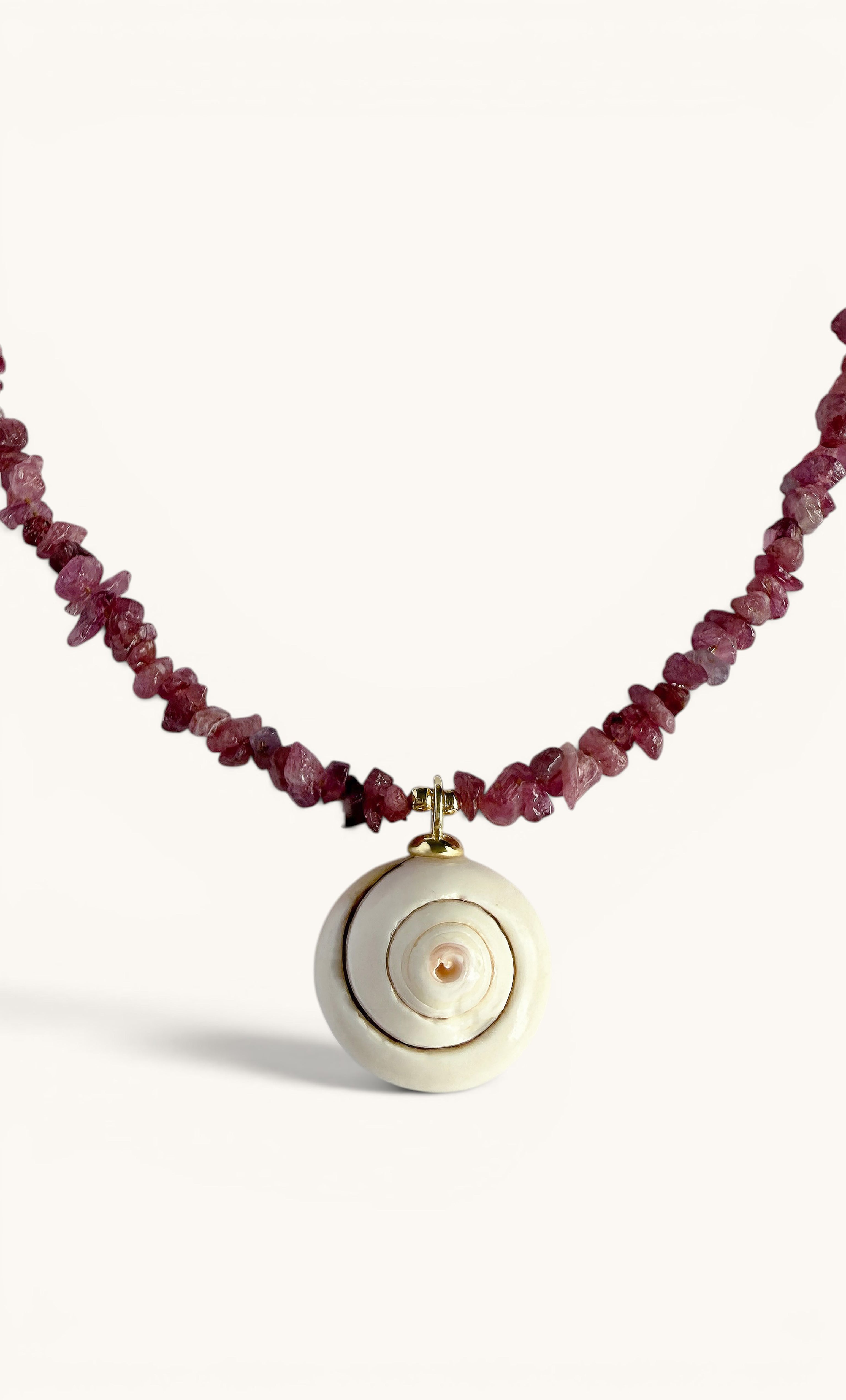 Gold fill necklace with irregular pink tourmaline beads and a round white shell charm pendant.