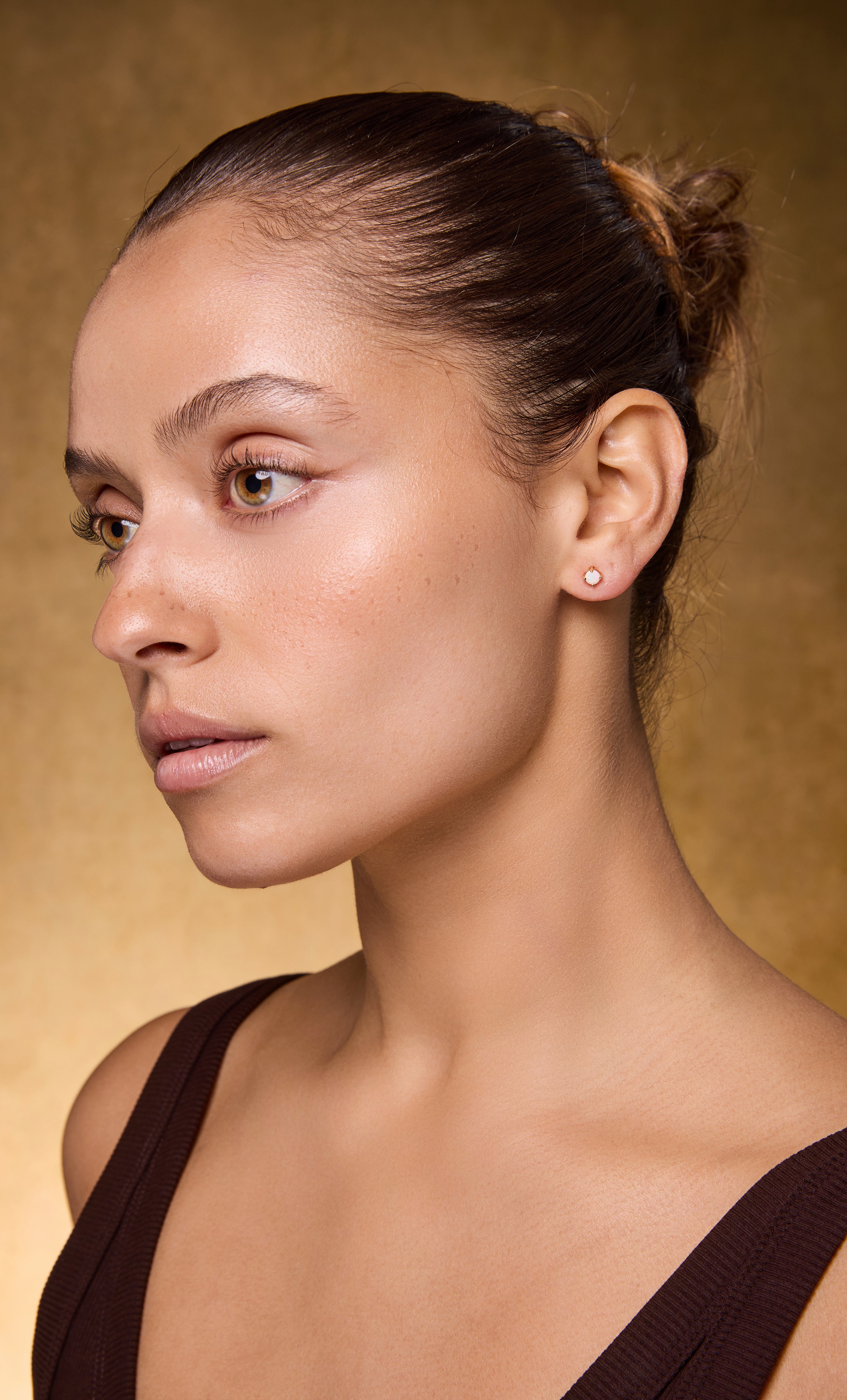 Woman wearing 14K gold fill opal stud earrings by Tunik, showcasing elegant jewellery gifts style.