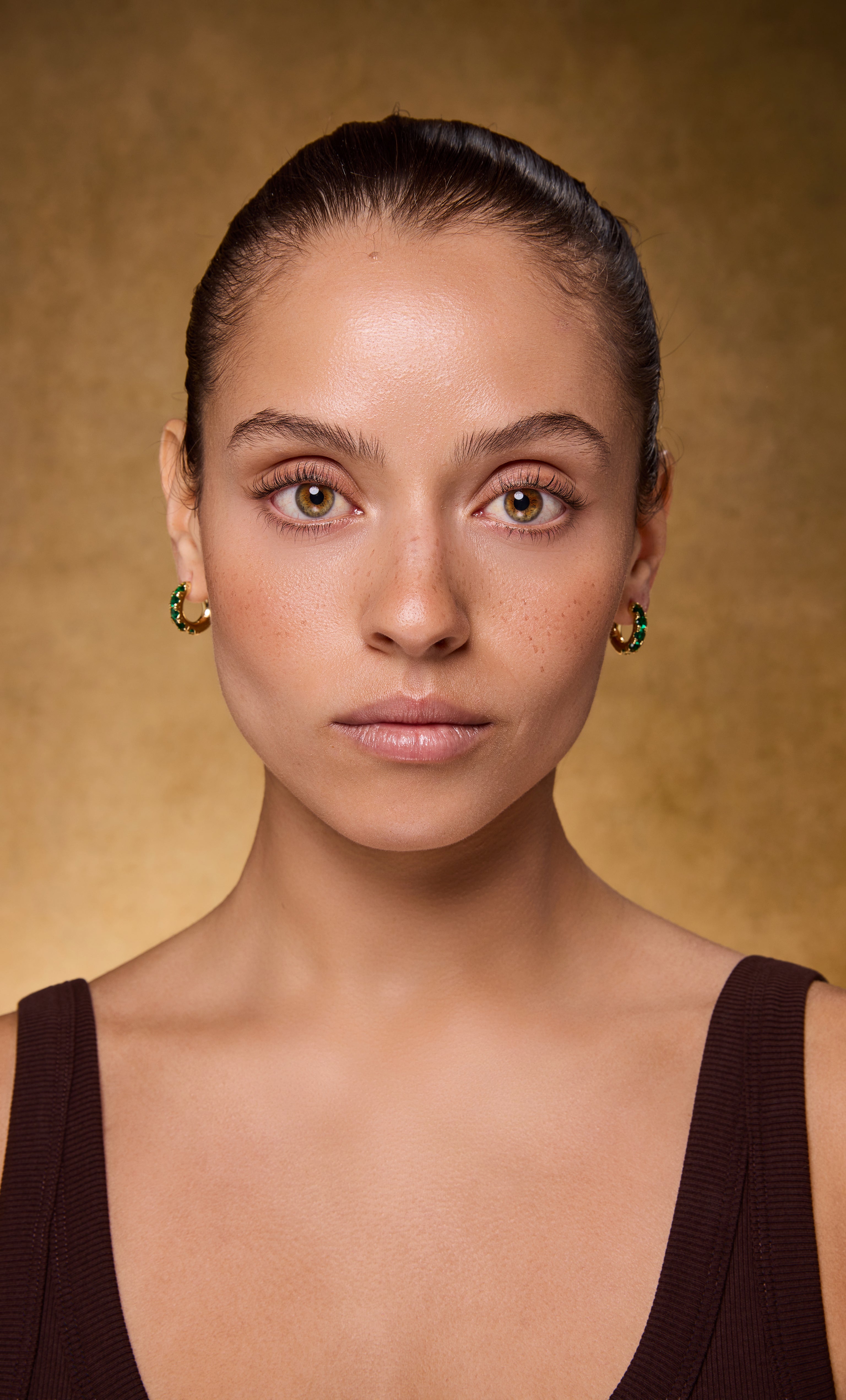 24K gold fill huggie earrings with emerald zirconia stones by Tunik, elegant jewellery gifts.