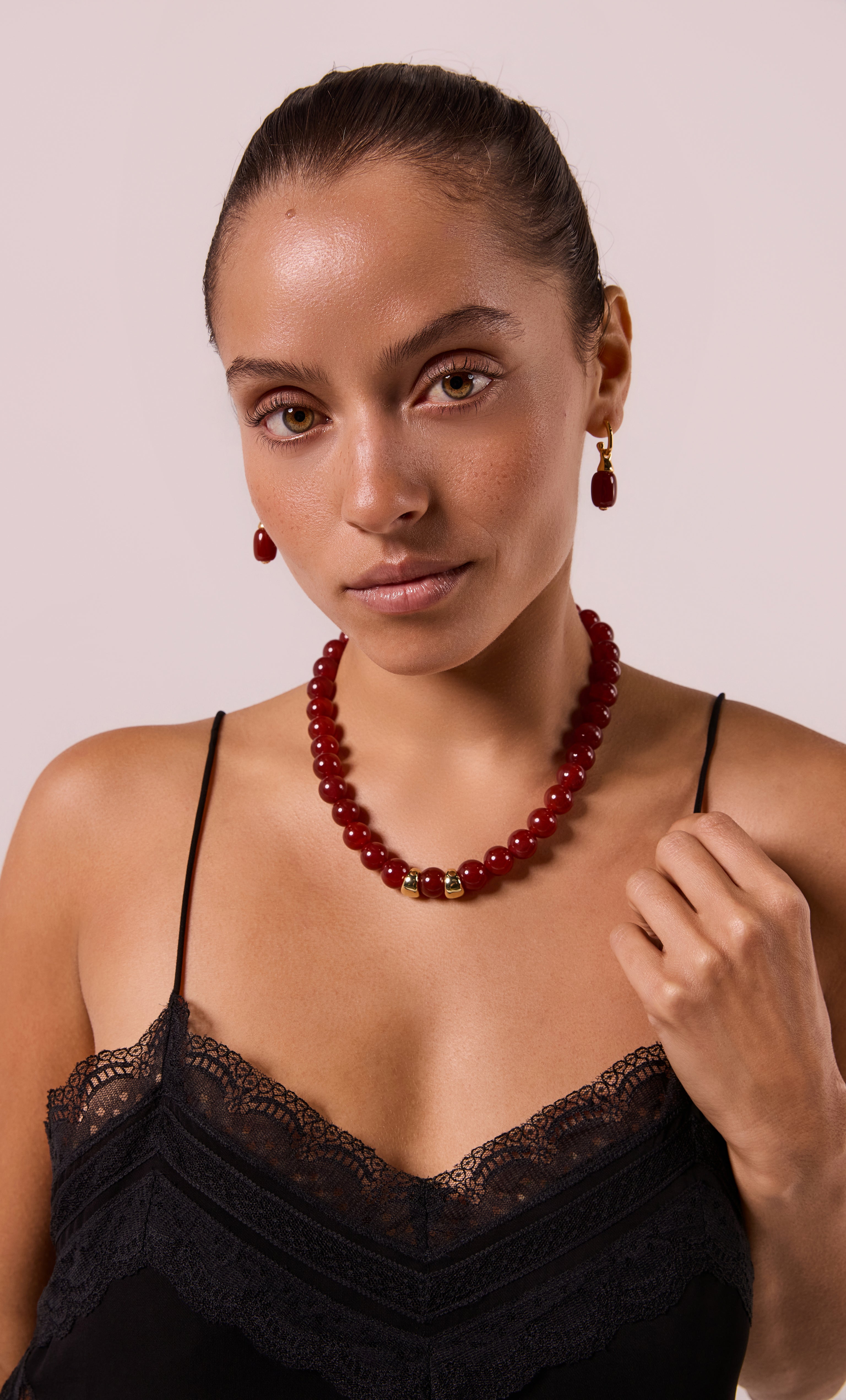 Red carnelian agate stone bead necklace with gold-fill clasp, styled with matching drop earrings.