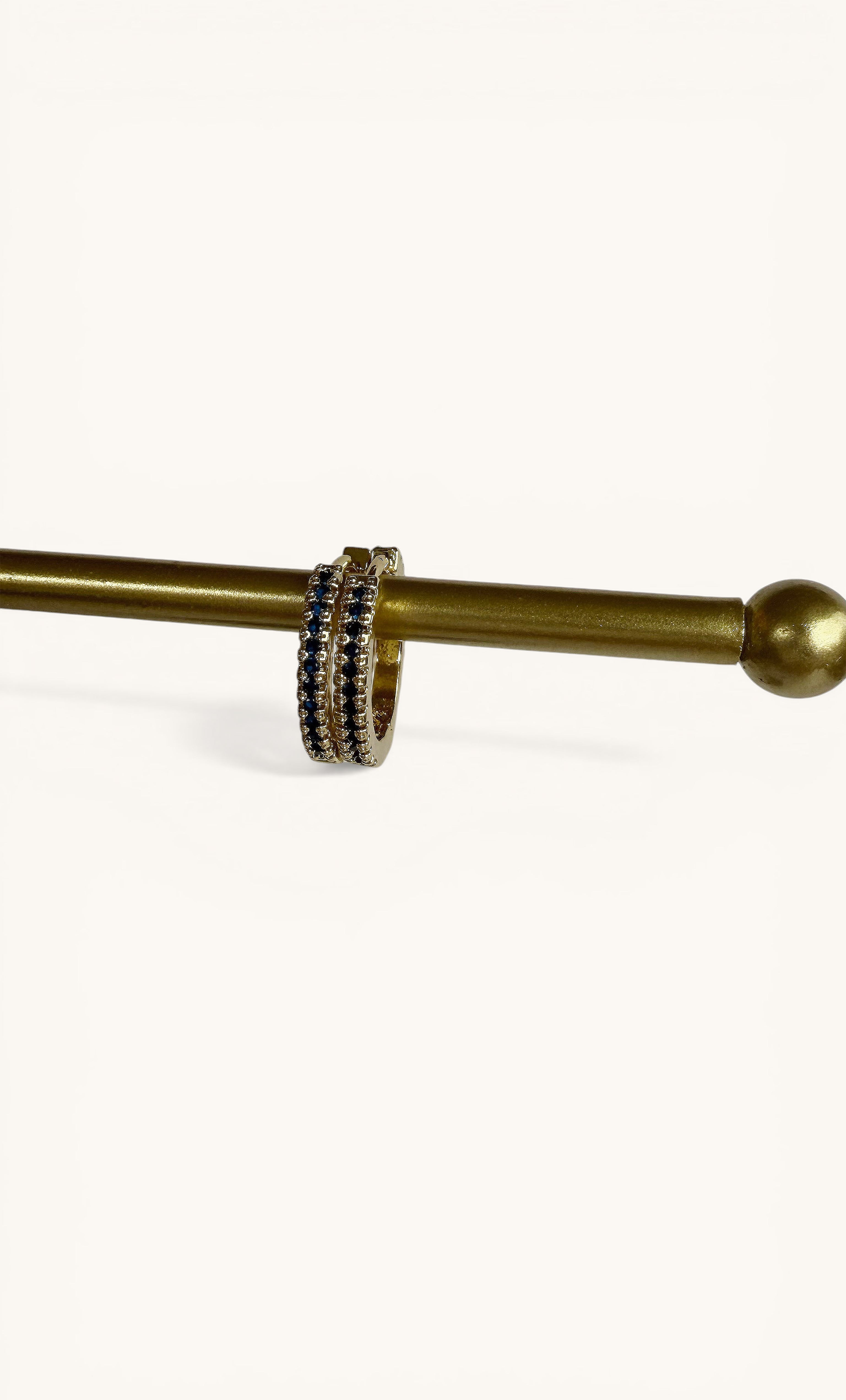 Gaia 24K gold fill huggie earrings with blue sapphire zirconia stones by Tunik the Label jewelry gifts.