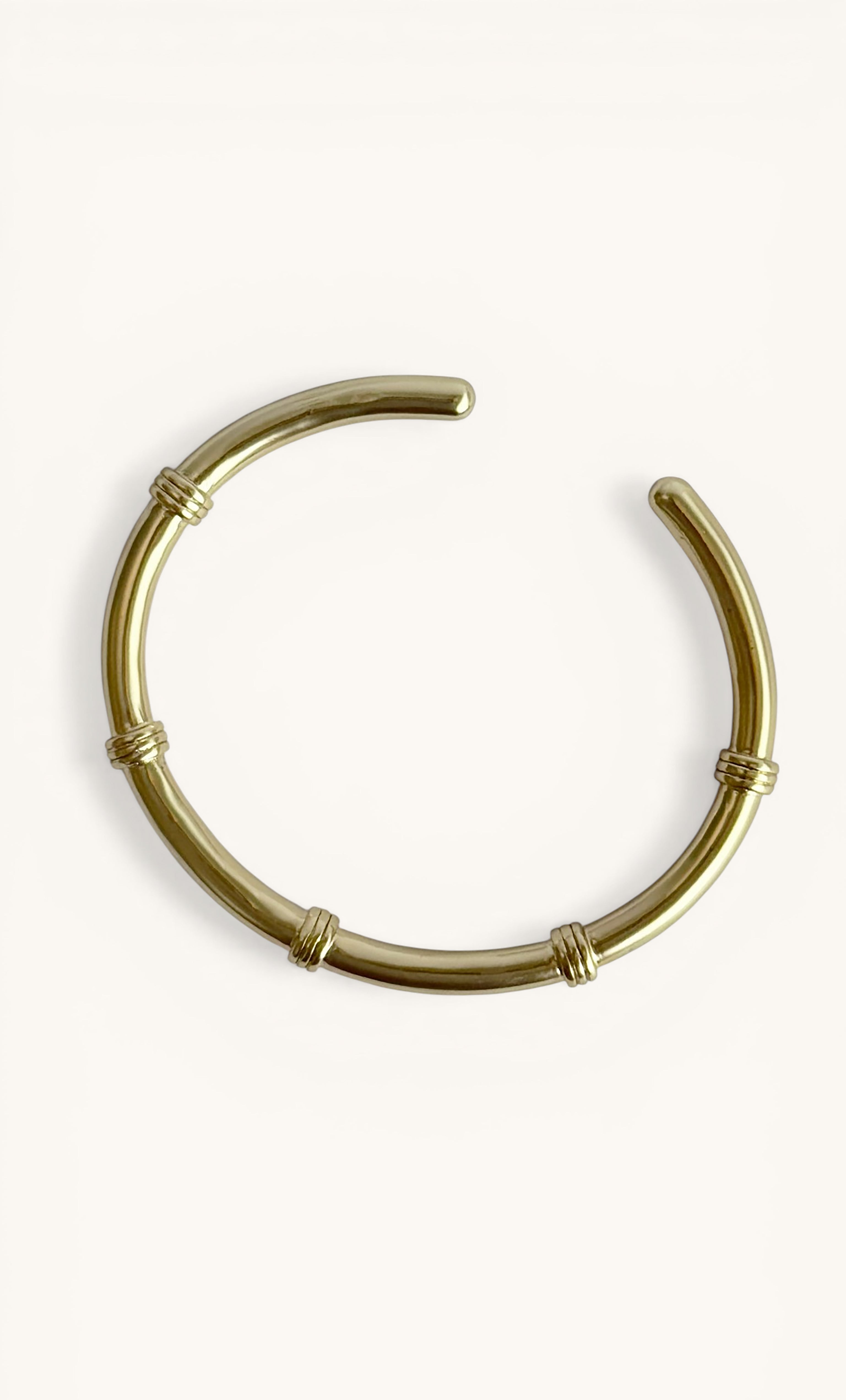 24K gold fill connection cuff bangle bracelet with smooth metal and subtle ring accents by Tunik The Label, elegant.