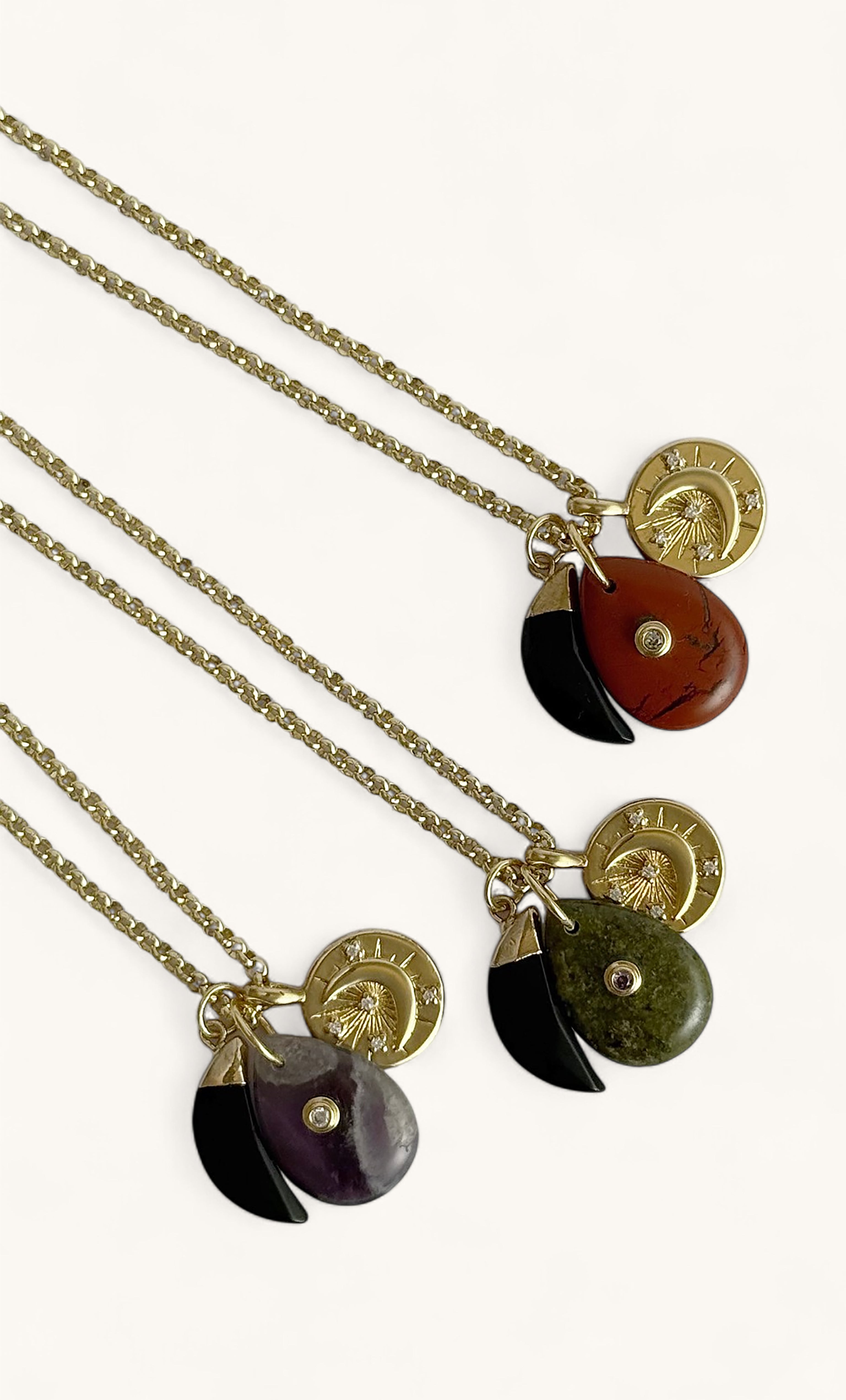 Tunik gold fill rolo chain necklaces with carnelian, black, and green stone charms and round Tunik pendants.