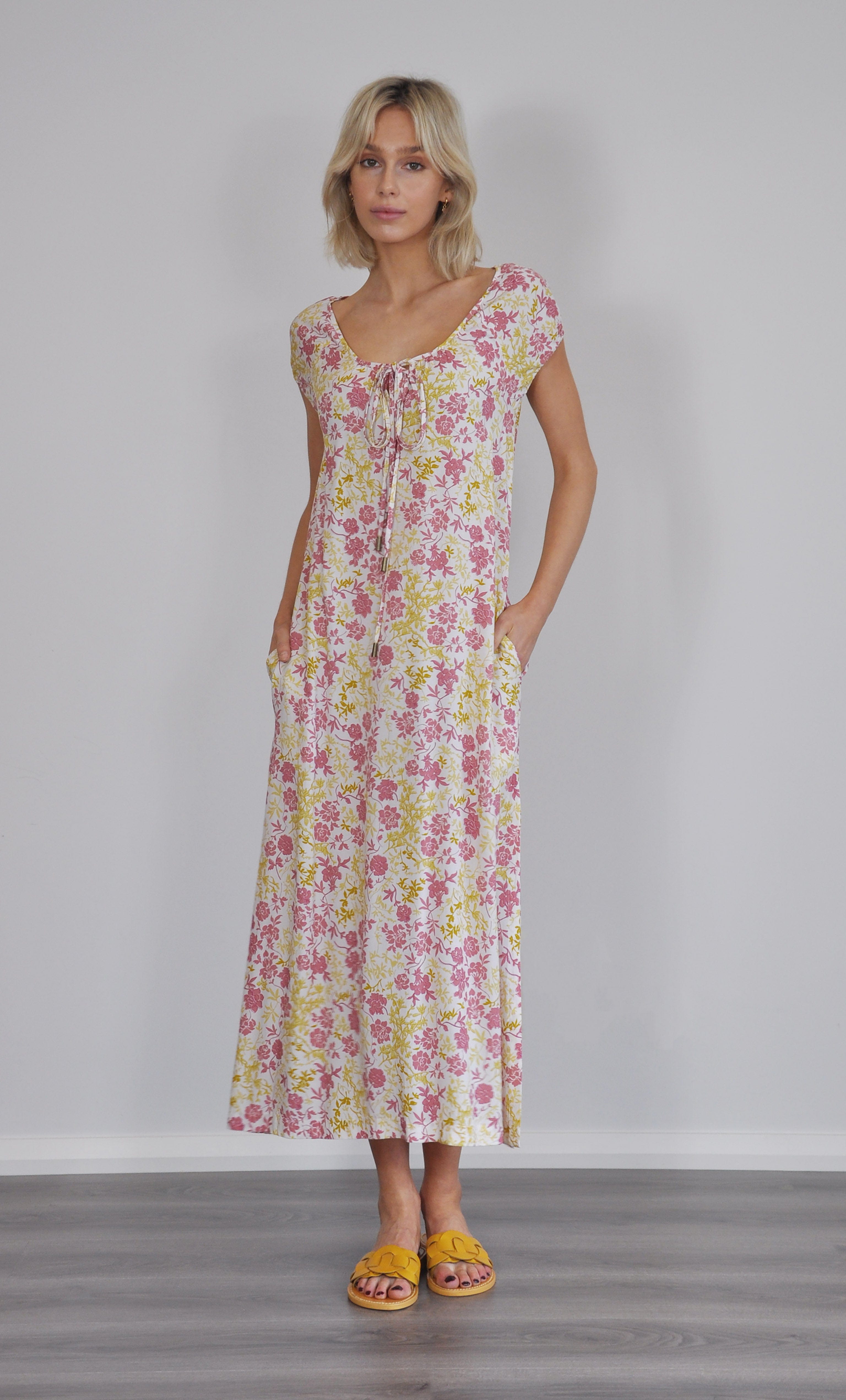 Summer floral blooms Aurelia ruffle cover up dress by Tunik with gold fill necklace and yellow sandals.