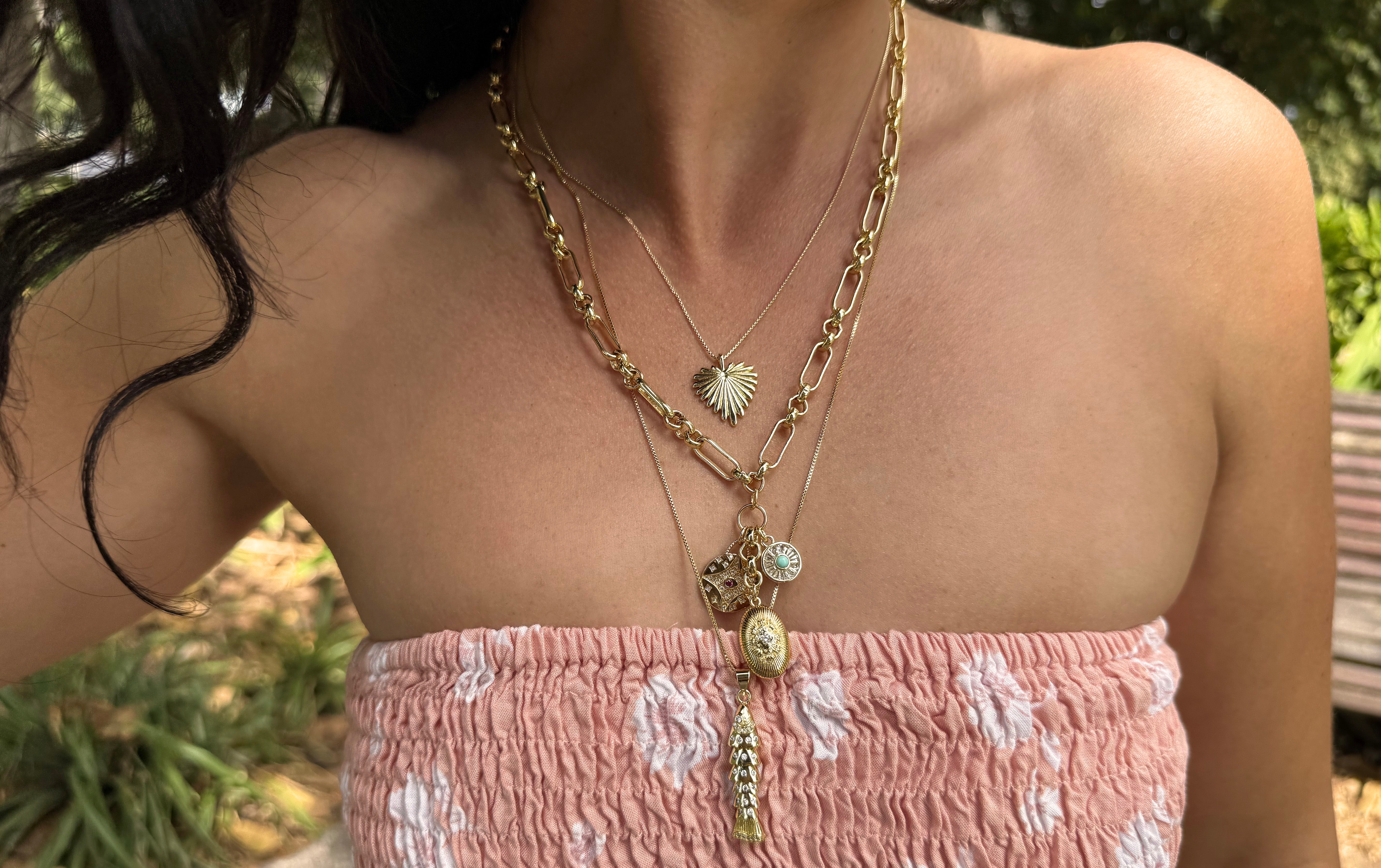 Model wearing Tunik Gold Fill Charm necklaces layered together