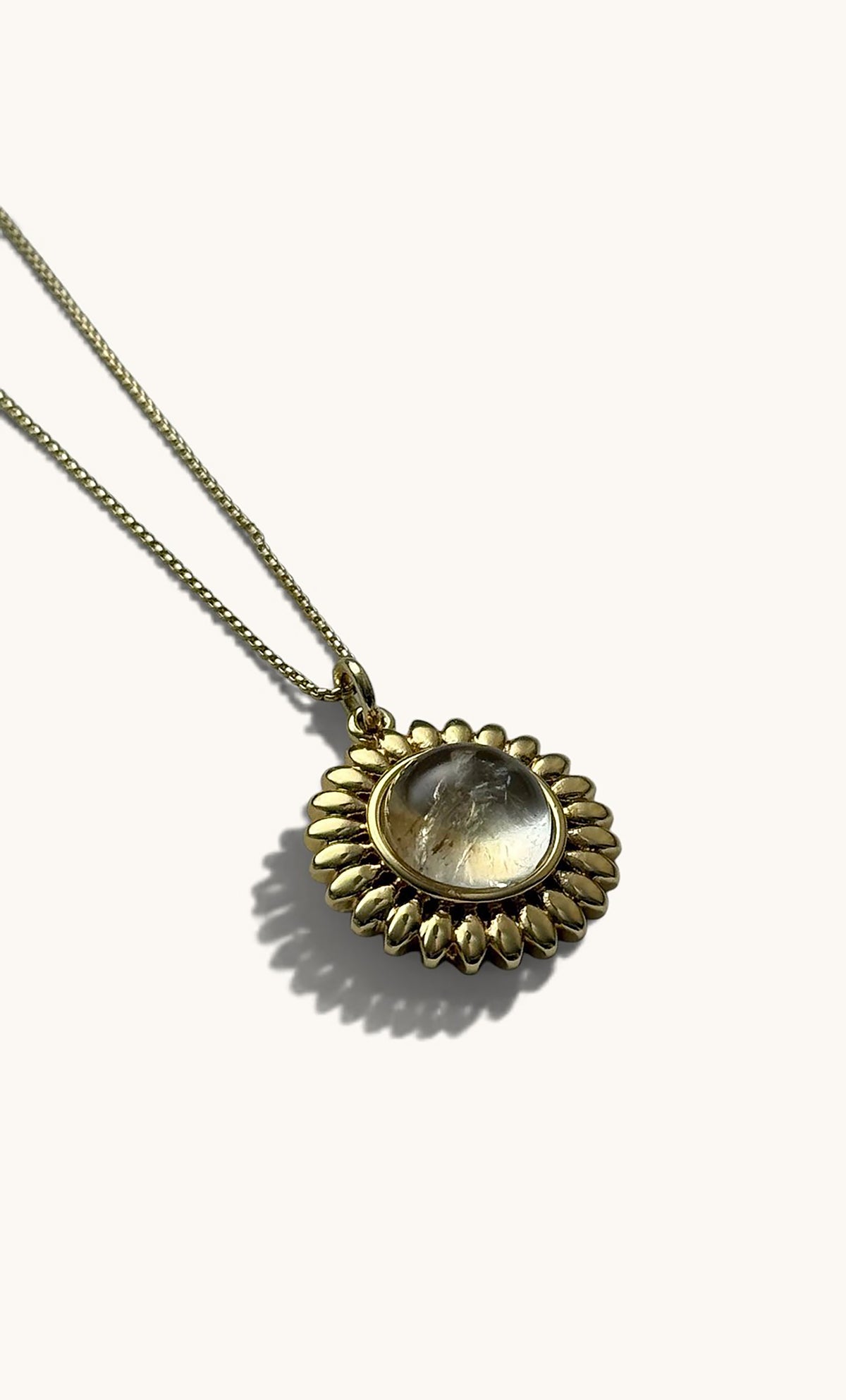 14K gold fill sun talisman pendant with moonstone center on delicate gold chain.