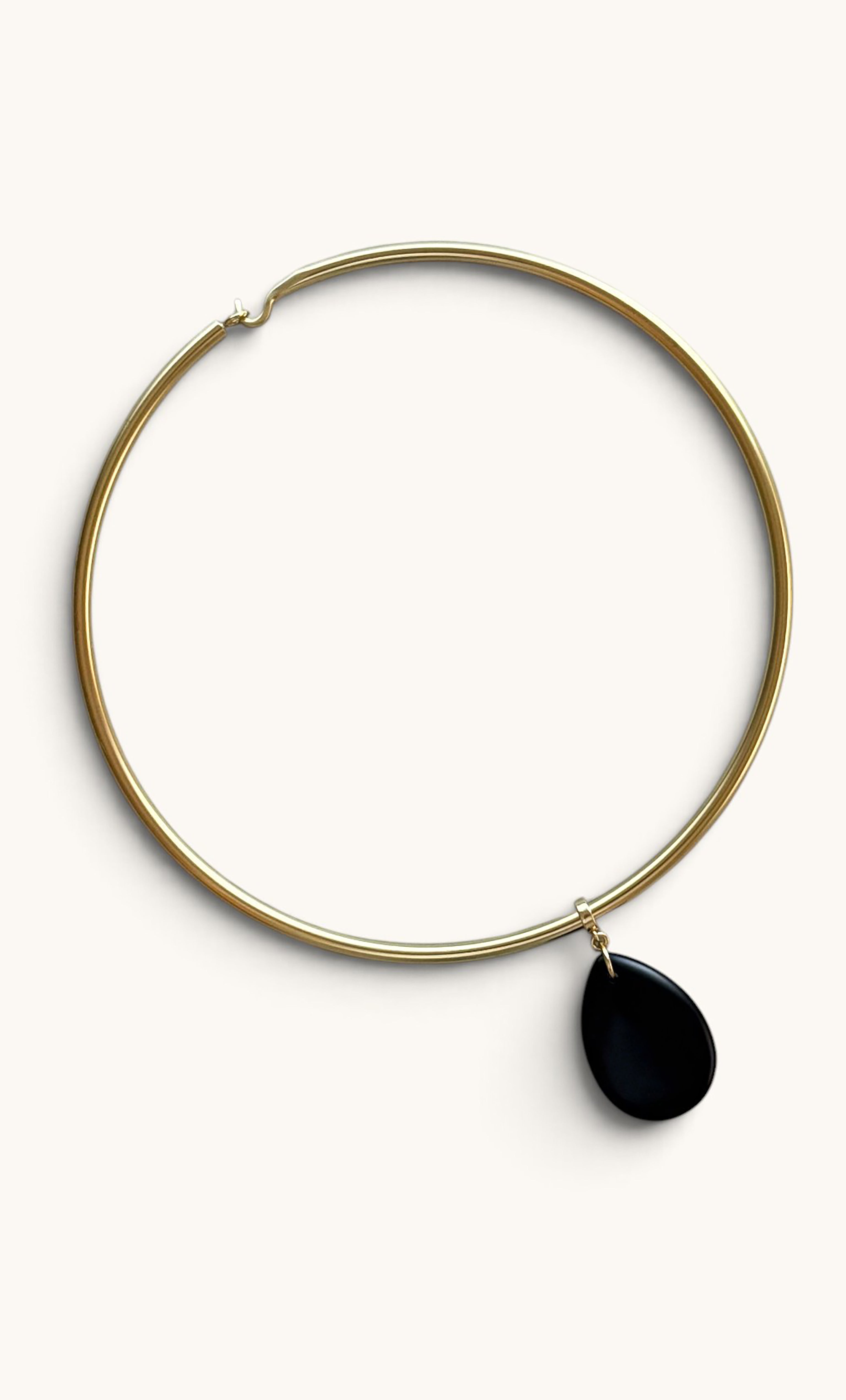 Gold fill collar necklace with a smooth black agate teardrop pendant from Tunik.