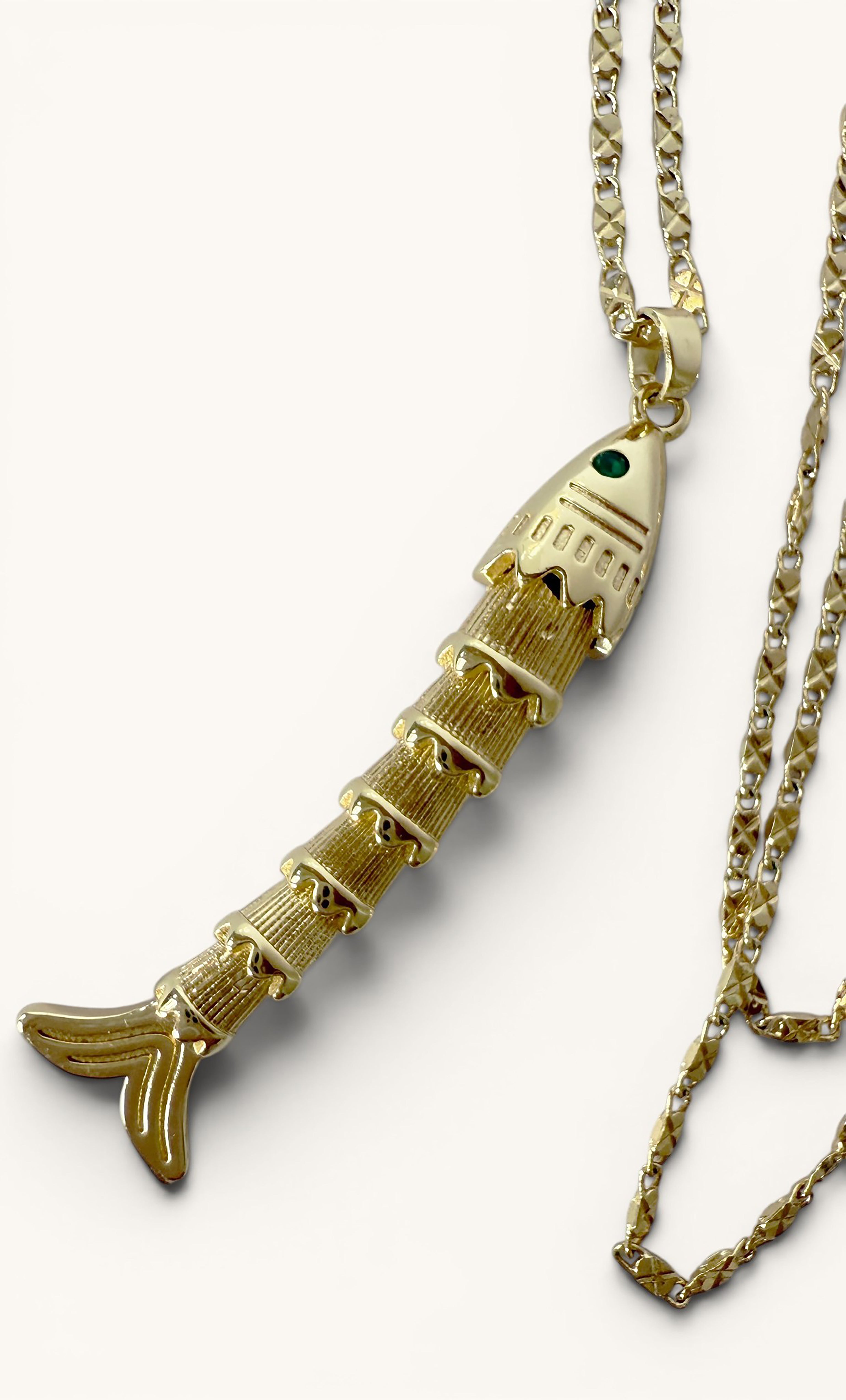 24K gold fill koi fish pendant with green eye on a matching gold chain necklace.