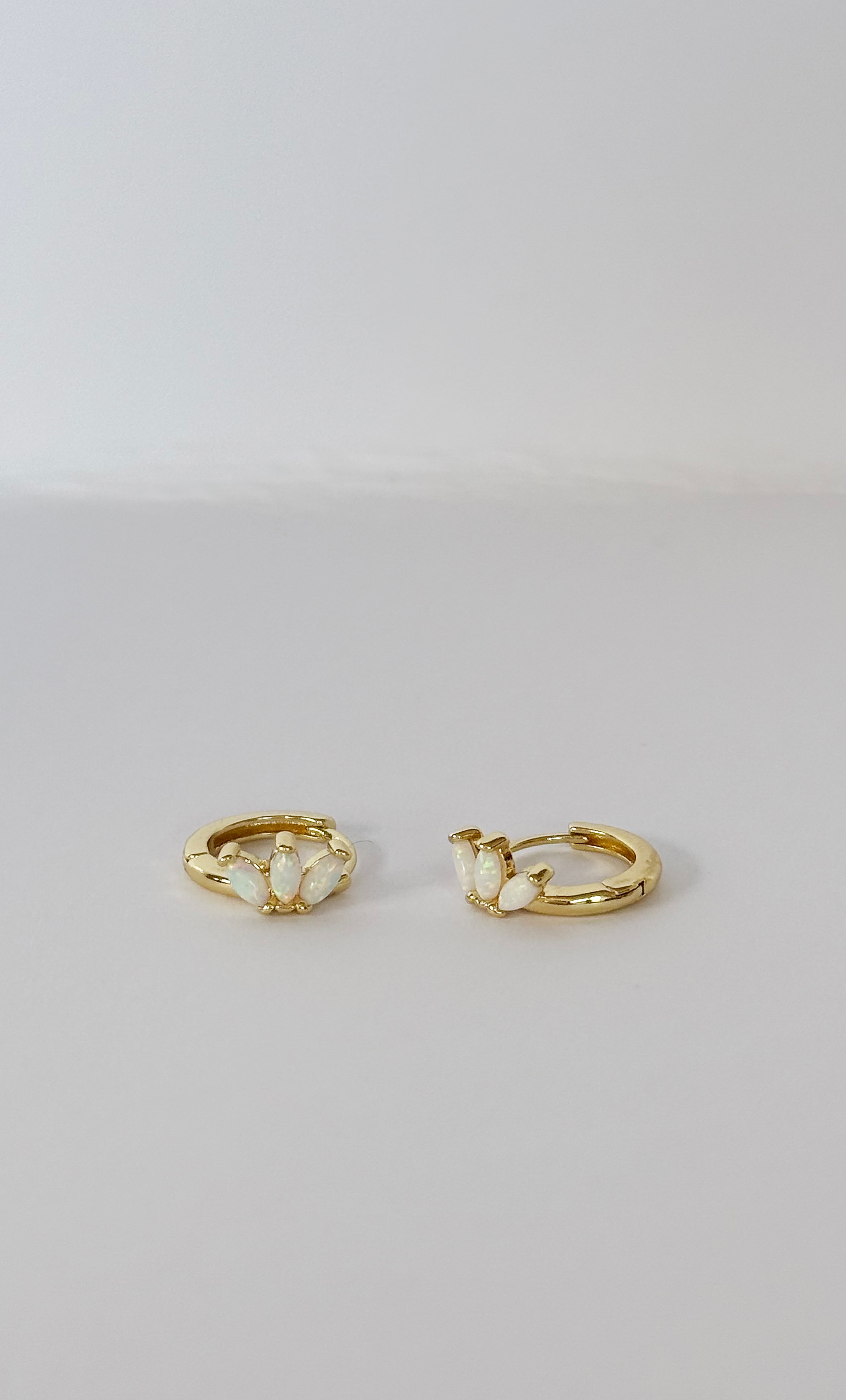 The Tunik White Opal Lumino Huggie Earrings