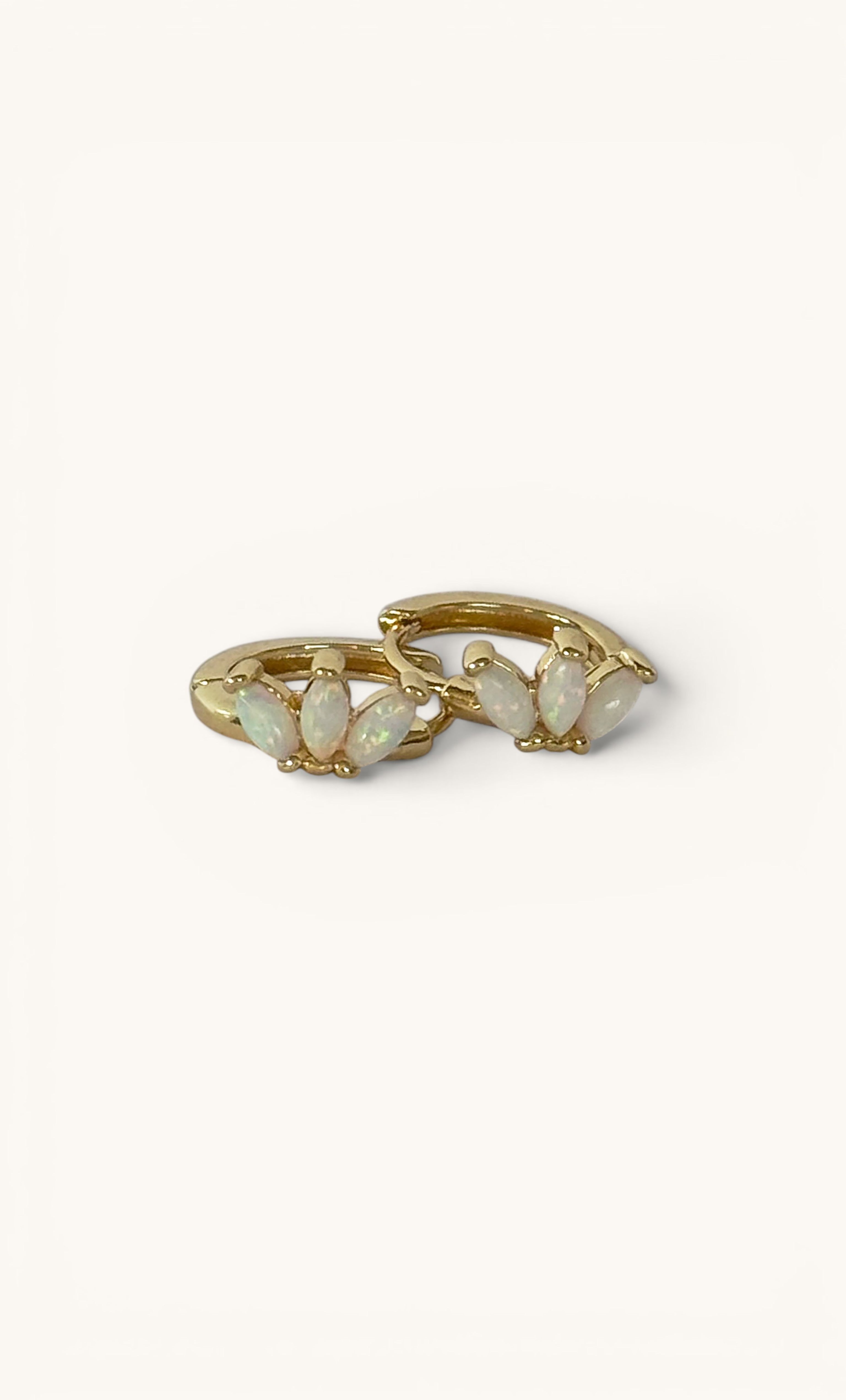 Gold fill huggie earrings with delicate white opal stones from Tunik jewelry collection.