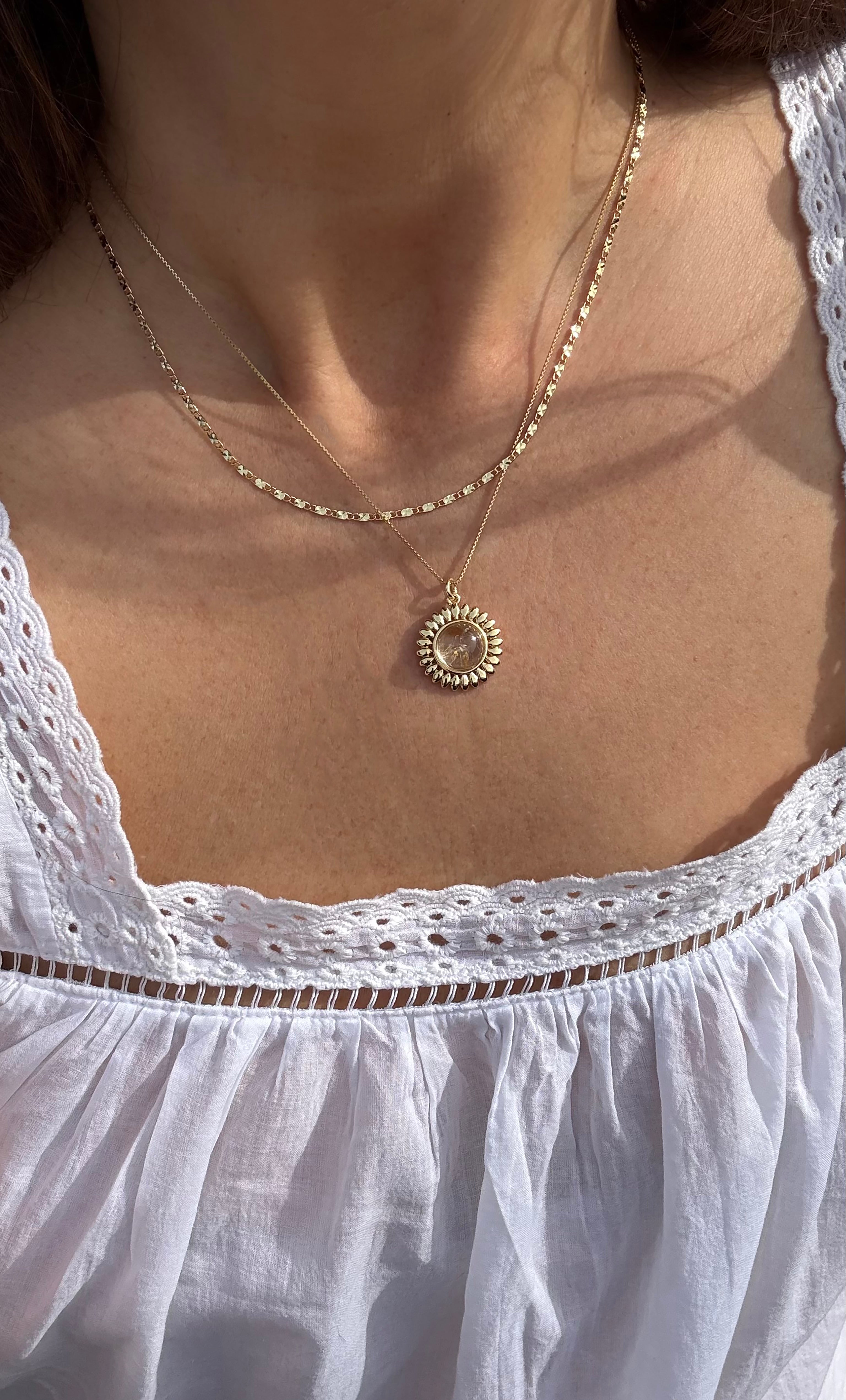 14K gold fill necklace with sun-shaped moonstone pendant on layered delicate chain.