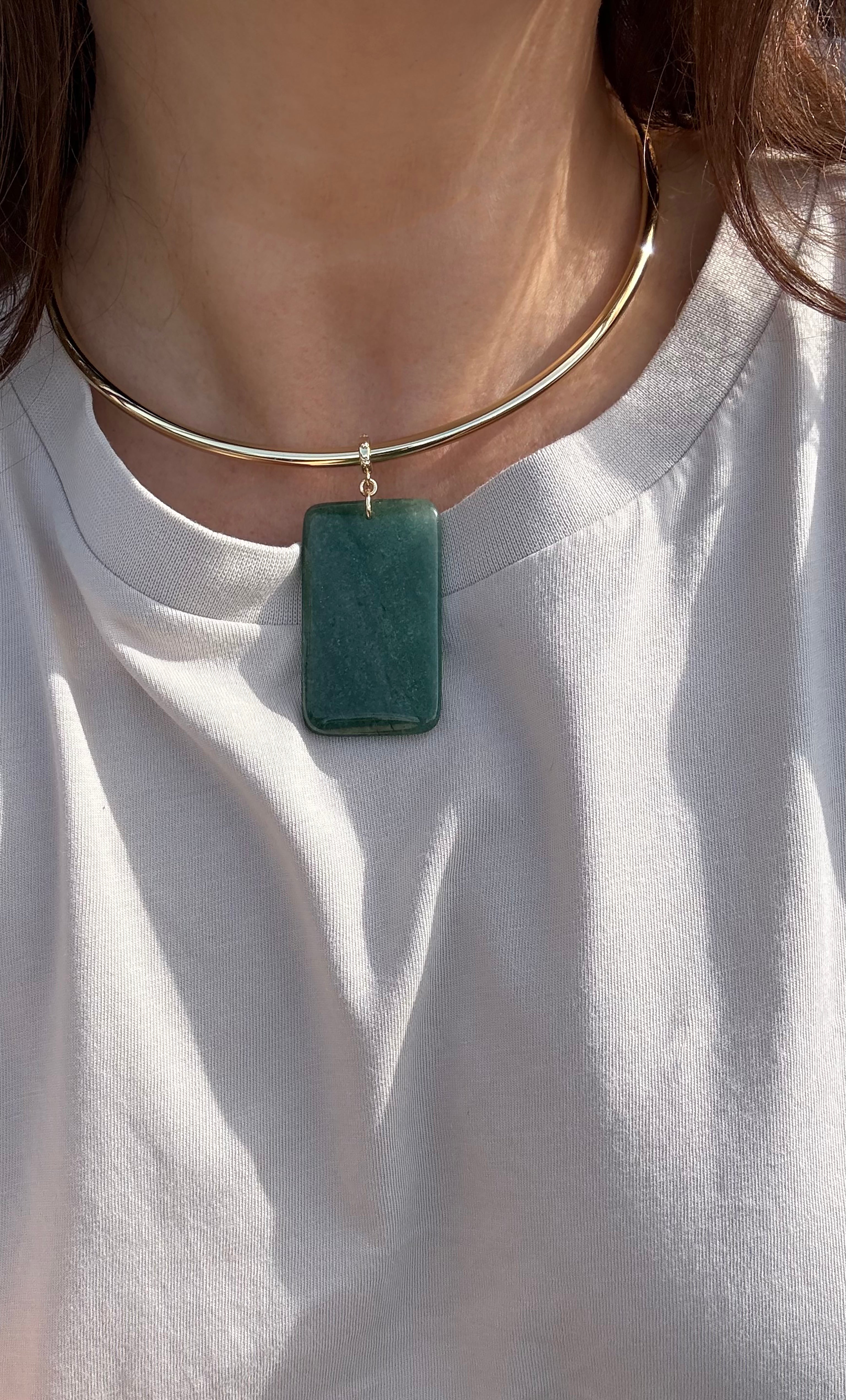 Gold fill collar necklace with rectangular green aventurine pendant on a white shirt.