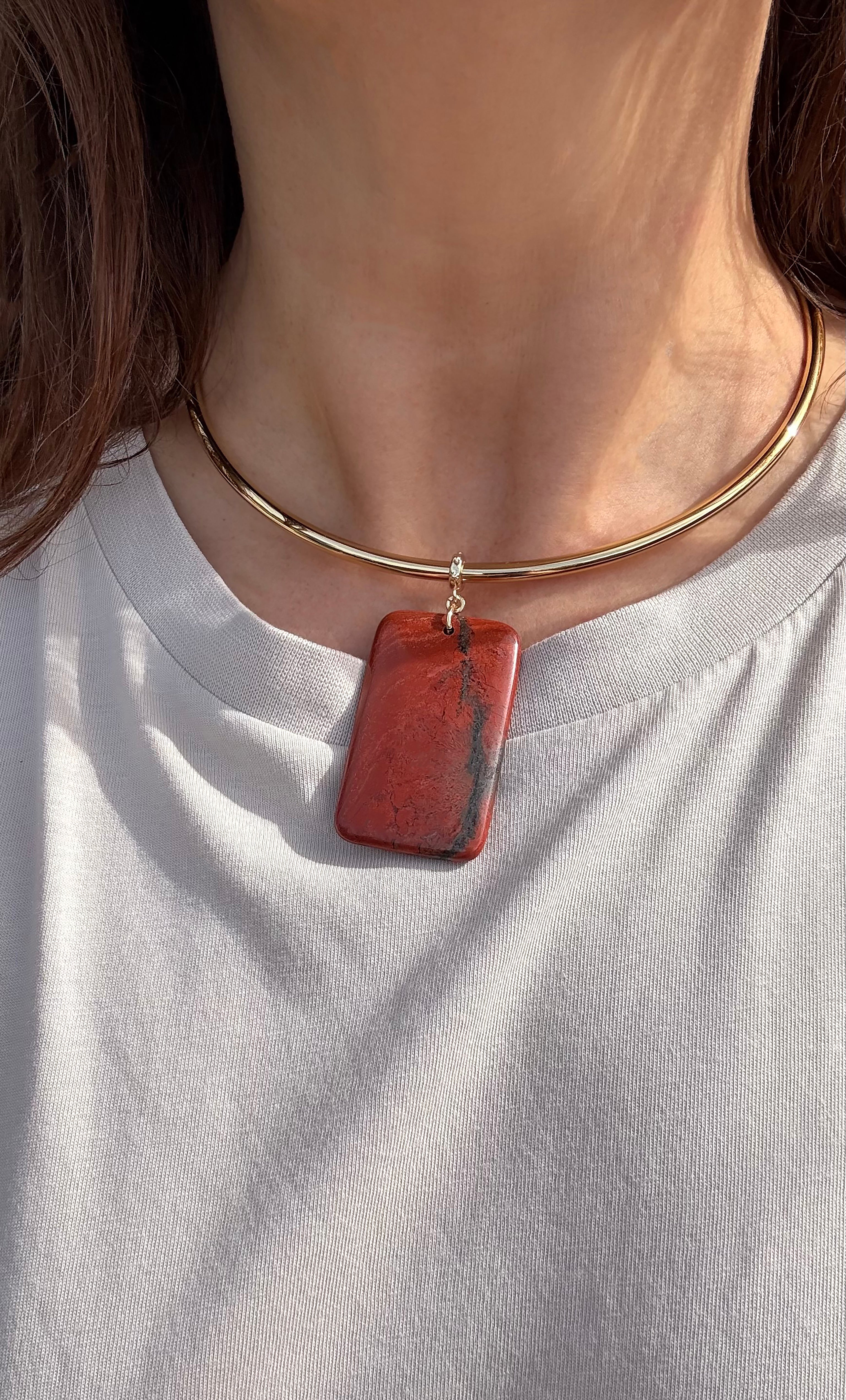 Gold fill collar necklace with rectangular red jasper pendant on a smooth chain.