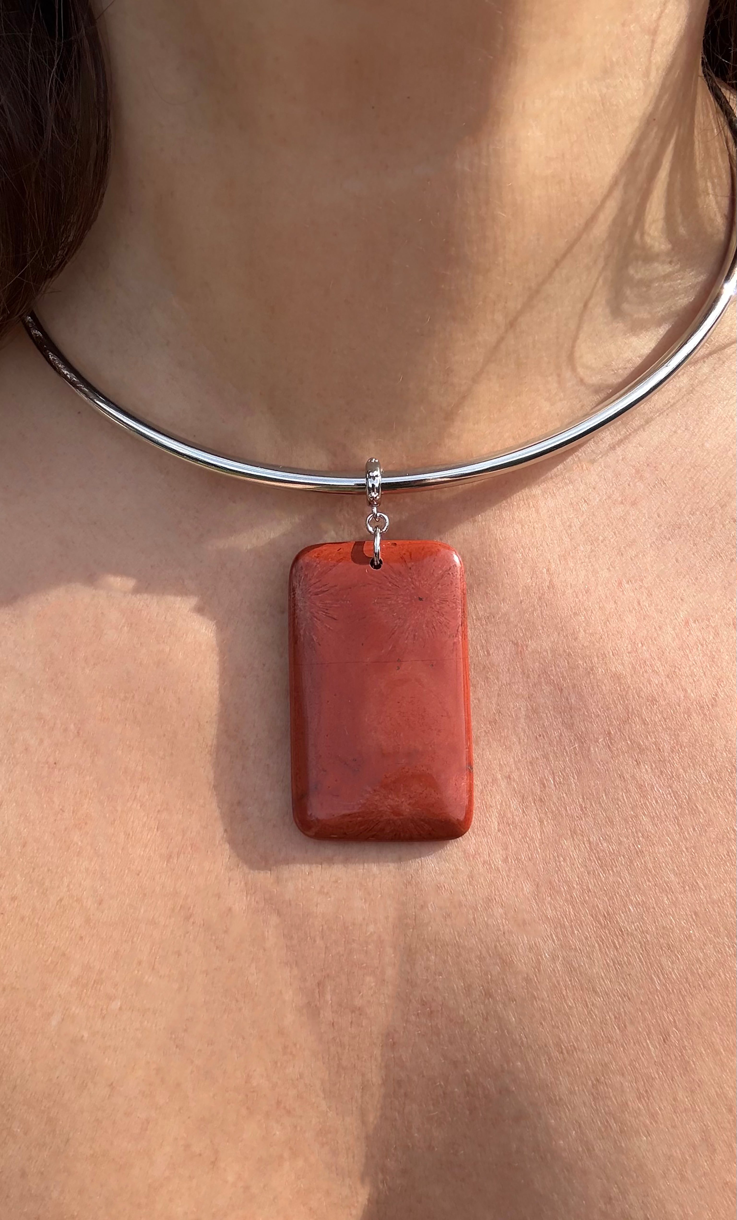 Silver collar necklace featuring a rectangular red jasper pendant with smooth polished surface.