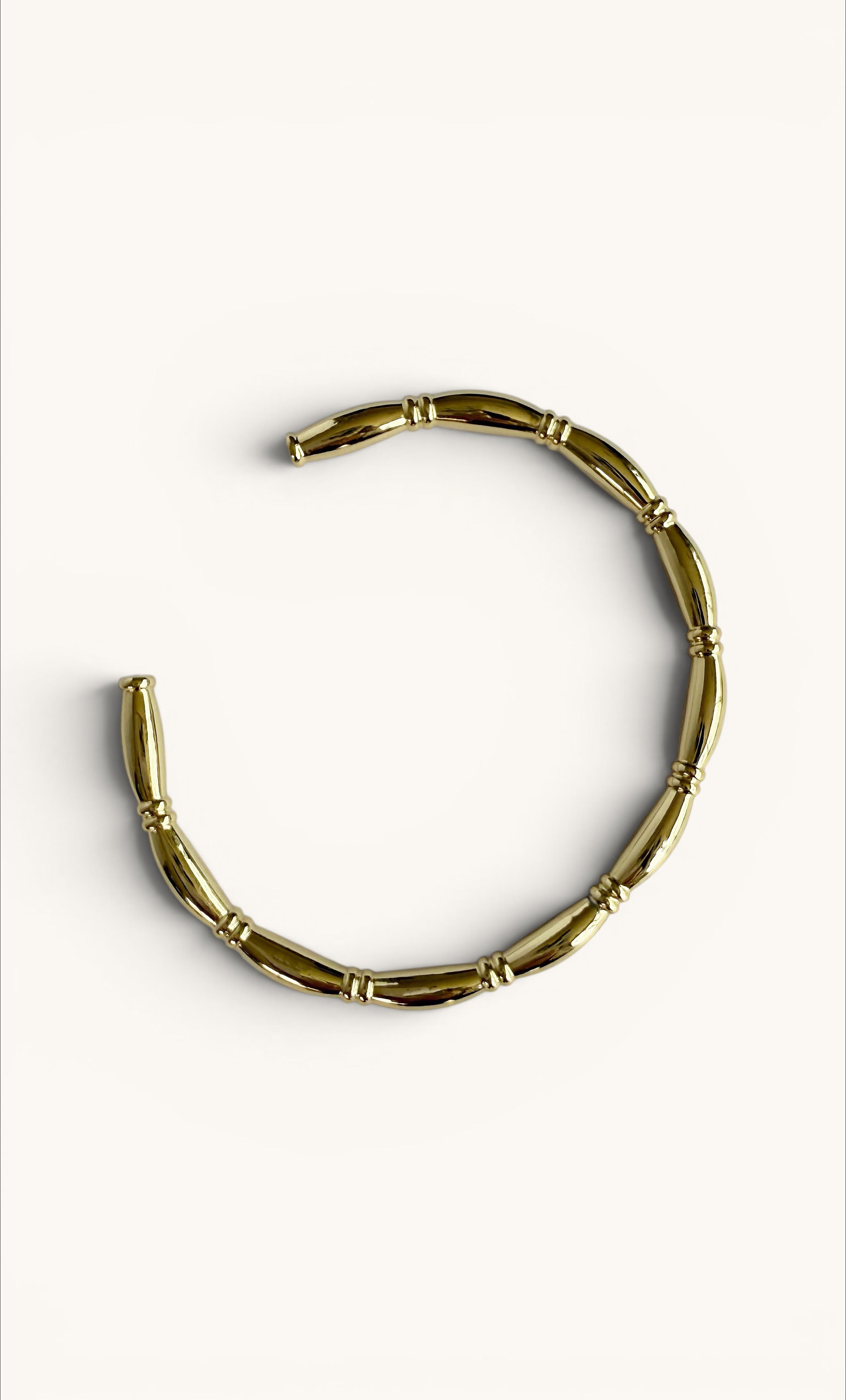 14K gold fill cuff bracelet with bamboo-inspired textured knot design.
