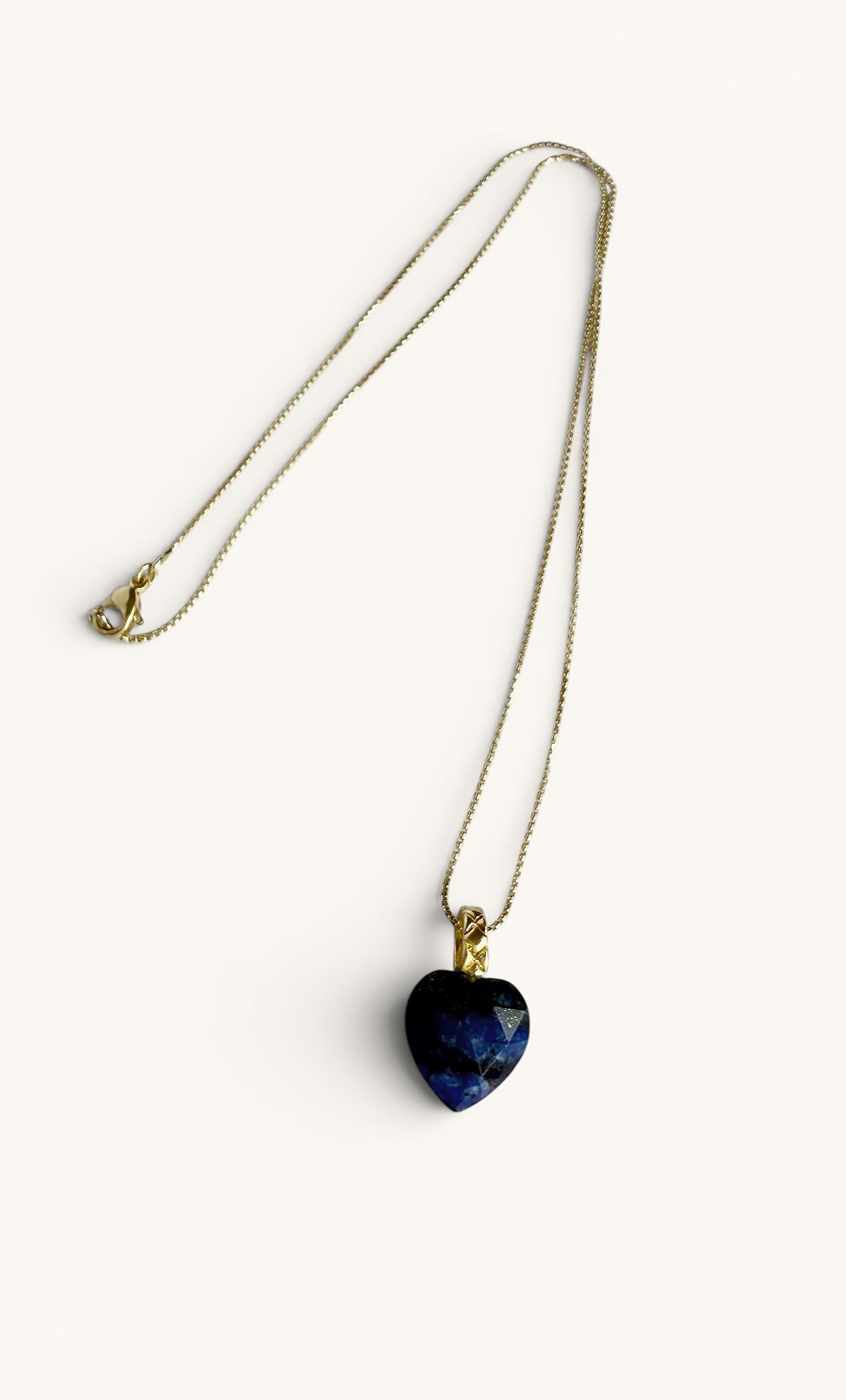 Gold fill necklace with a carved heart-shaped deep blue lapis lazuli pendant.