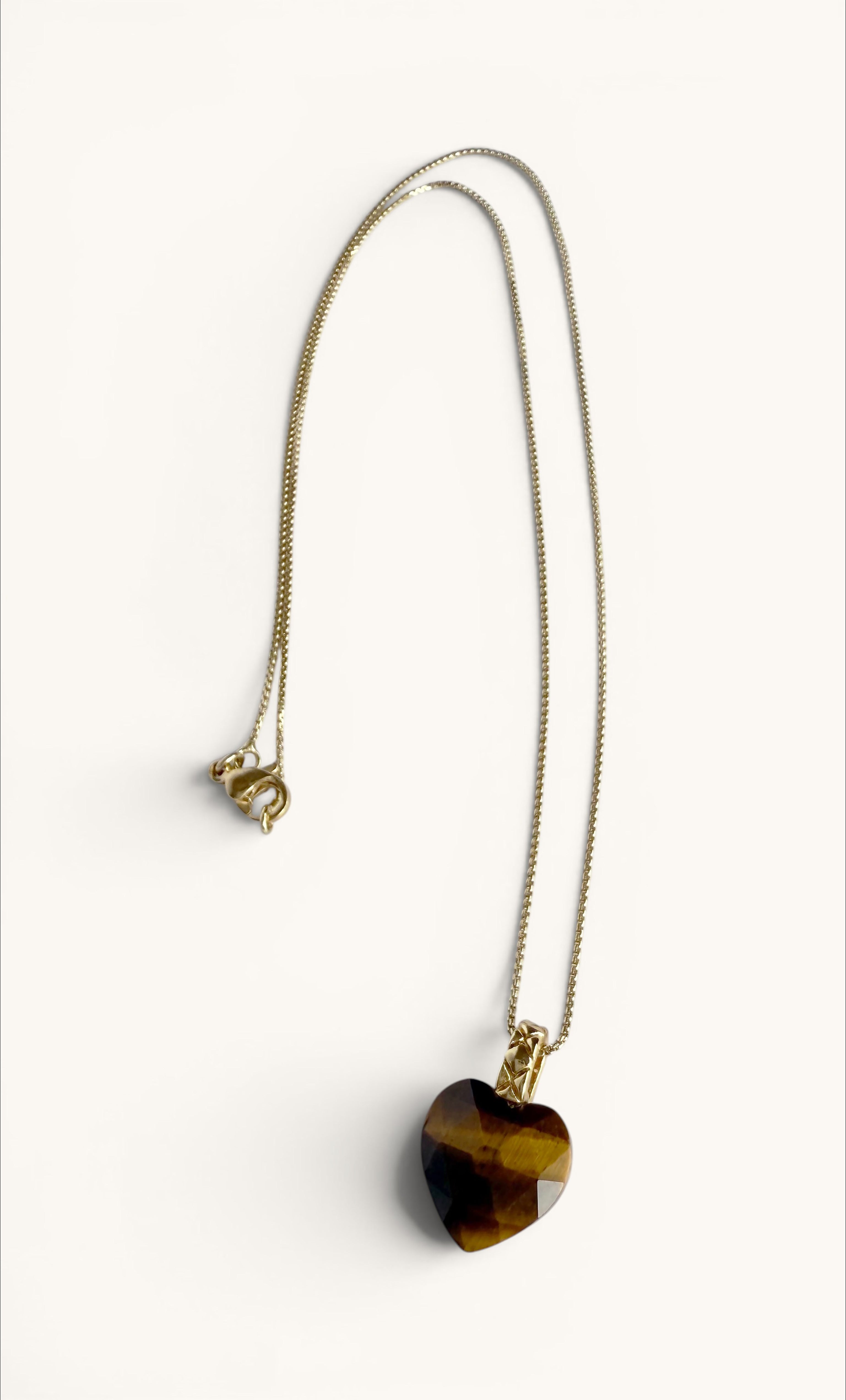 Gold fill necklace with carved heart-shaped tiger's eye stone pendant on delicate chain.