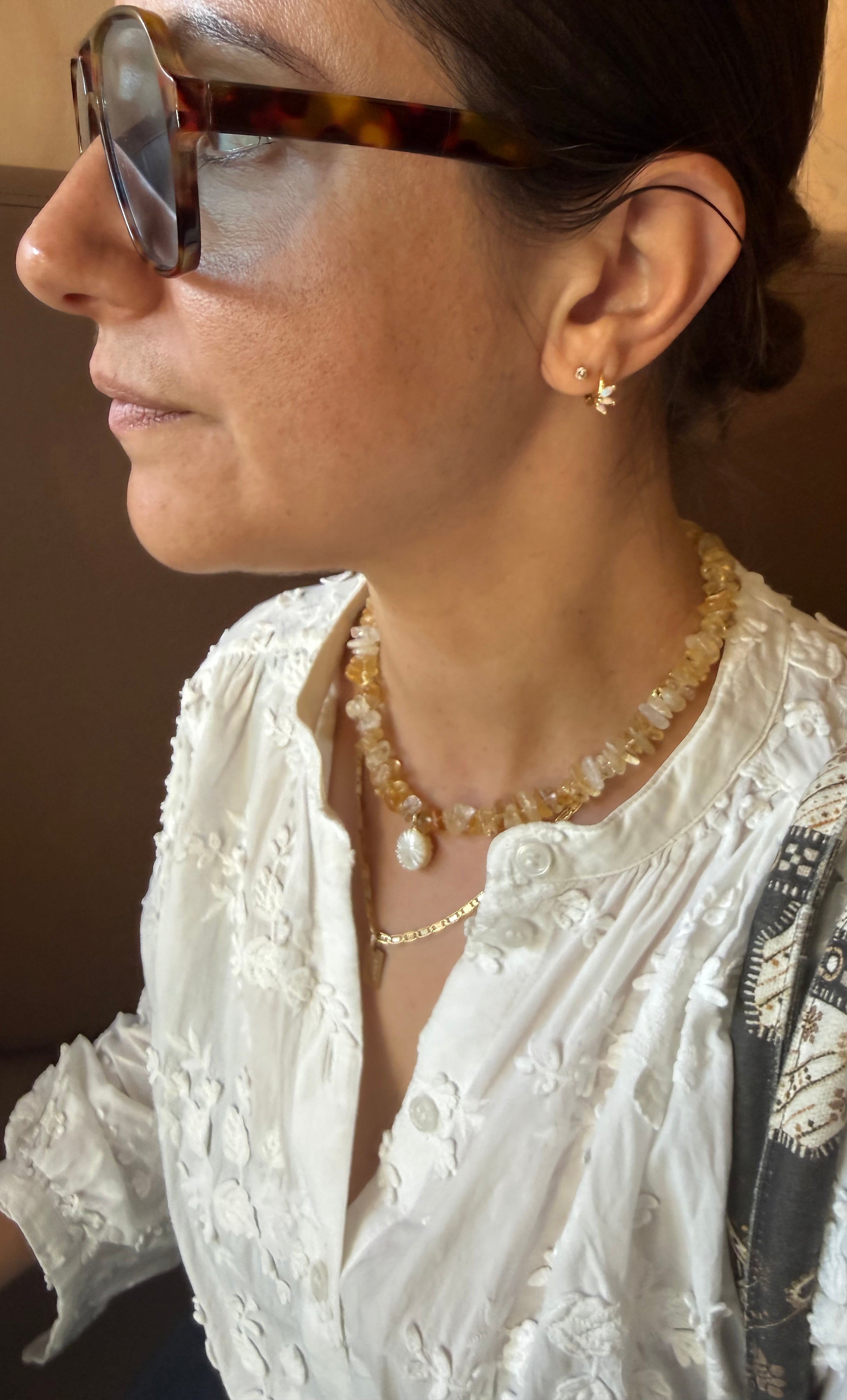 Gold fill Desert Bloom yellow citrine stone necklace with flower carved pendant by Tunik the label, styled with.