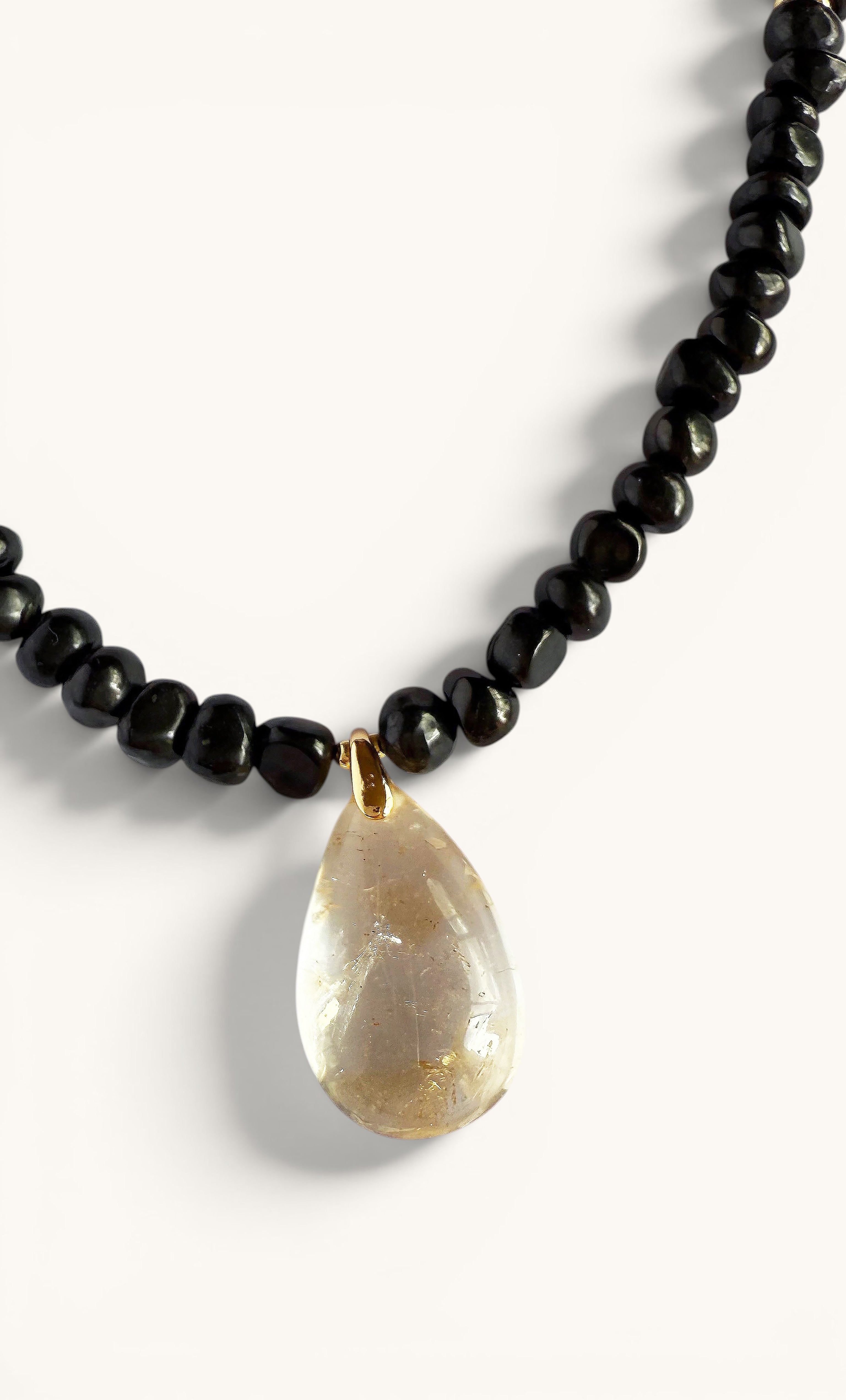Gold-fill necklace with polished black shungite pebble beads and teardrop-shaped citrine pendant.