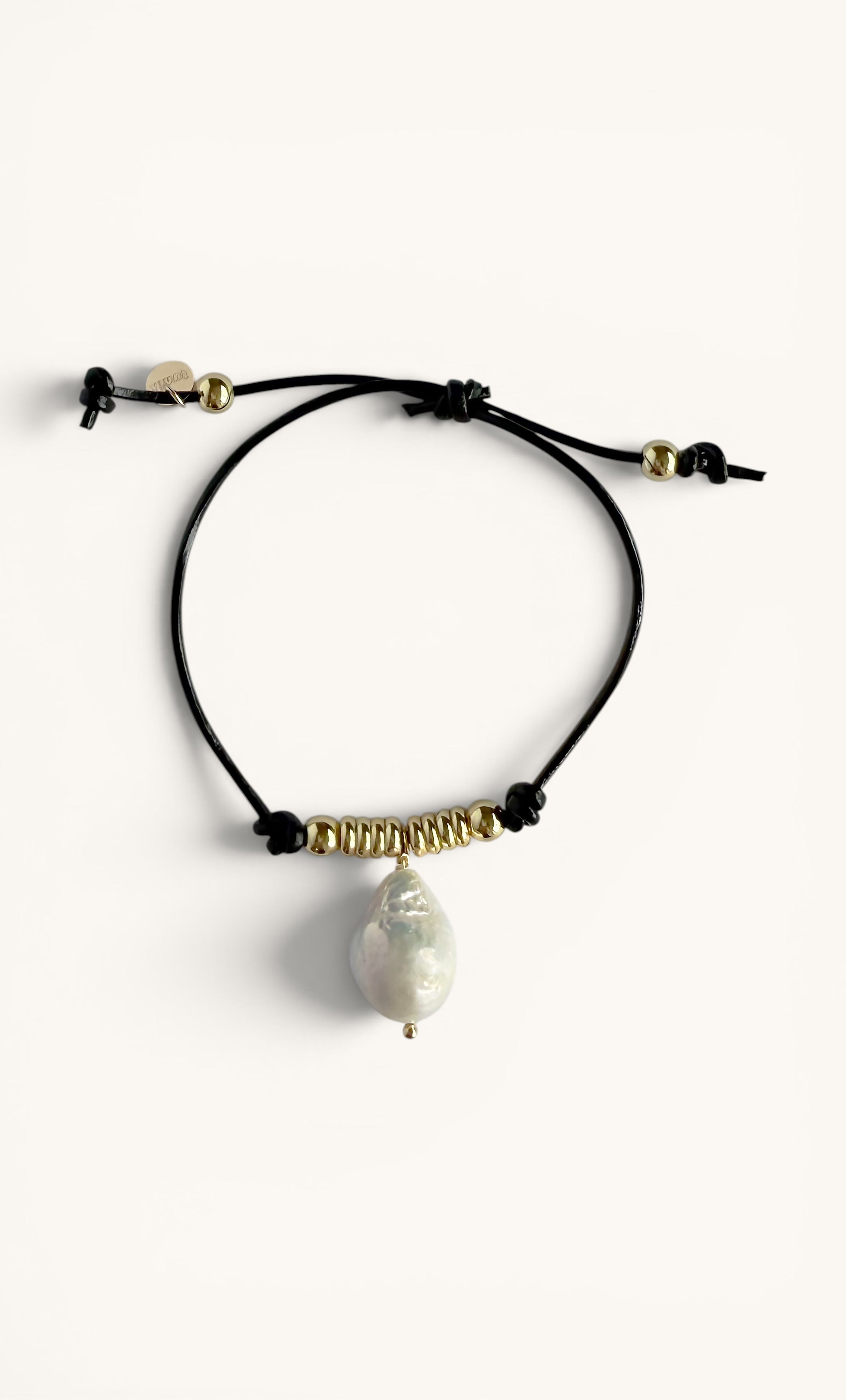 Black leather bracelet with baroque pearl drop and 24K gold fill bead accents.
