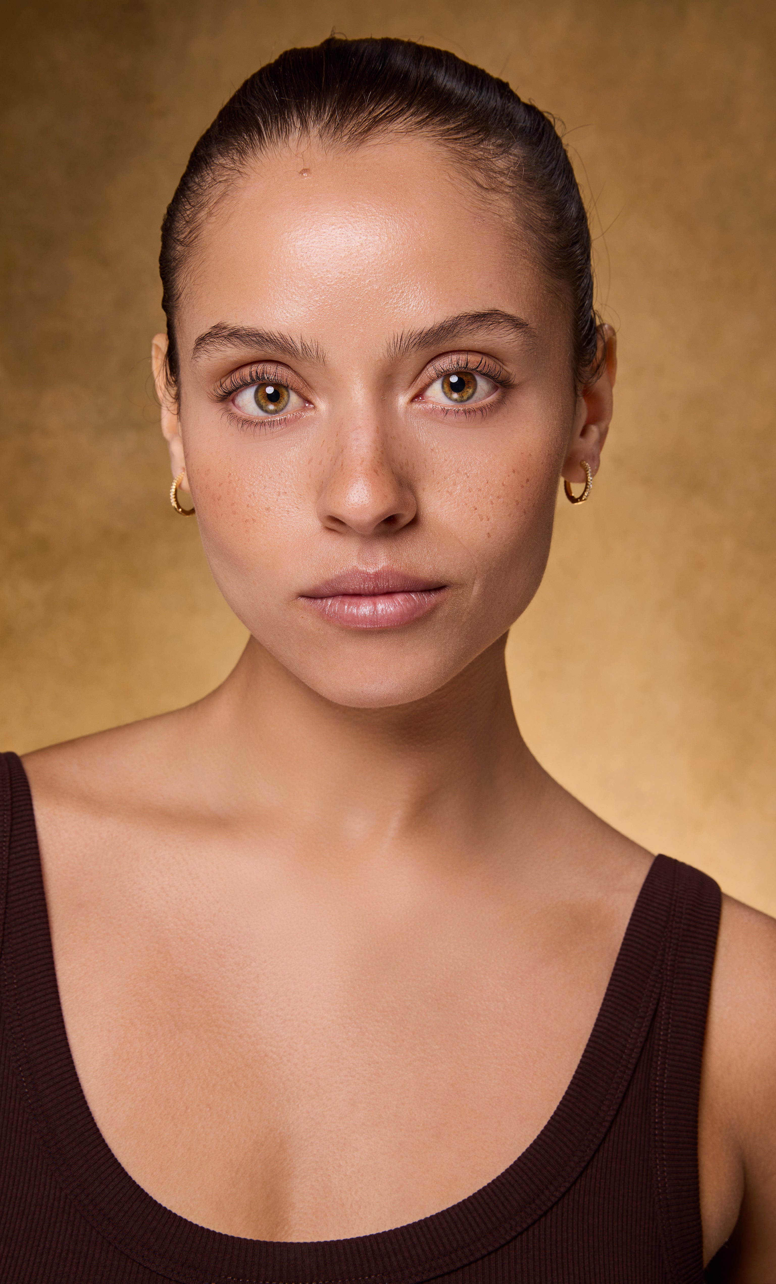 Gold fill Gaia 24K huggie earrings with clear zirconia stones by Tunik jewelry.