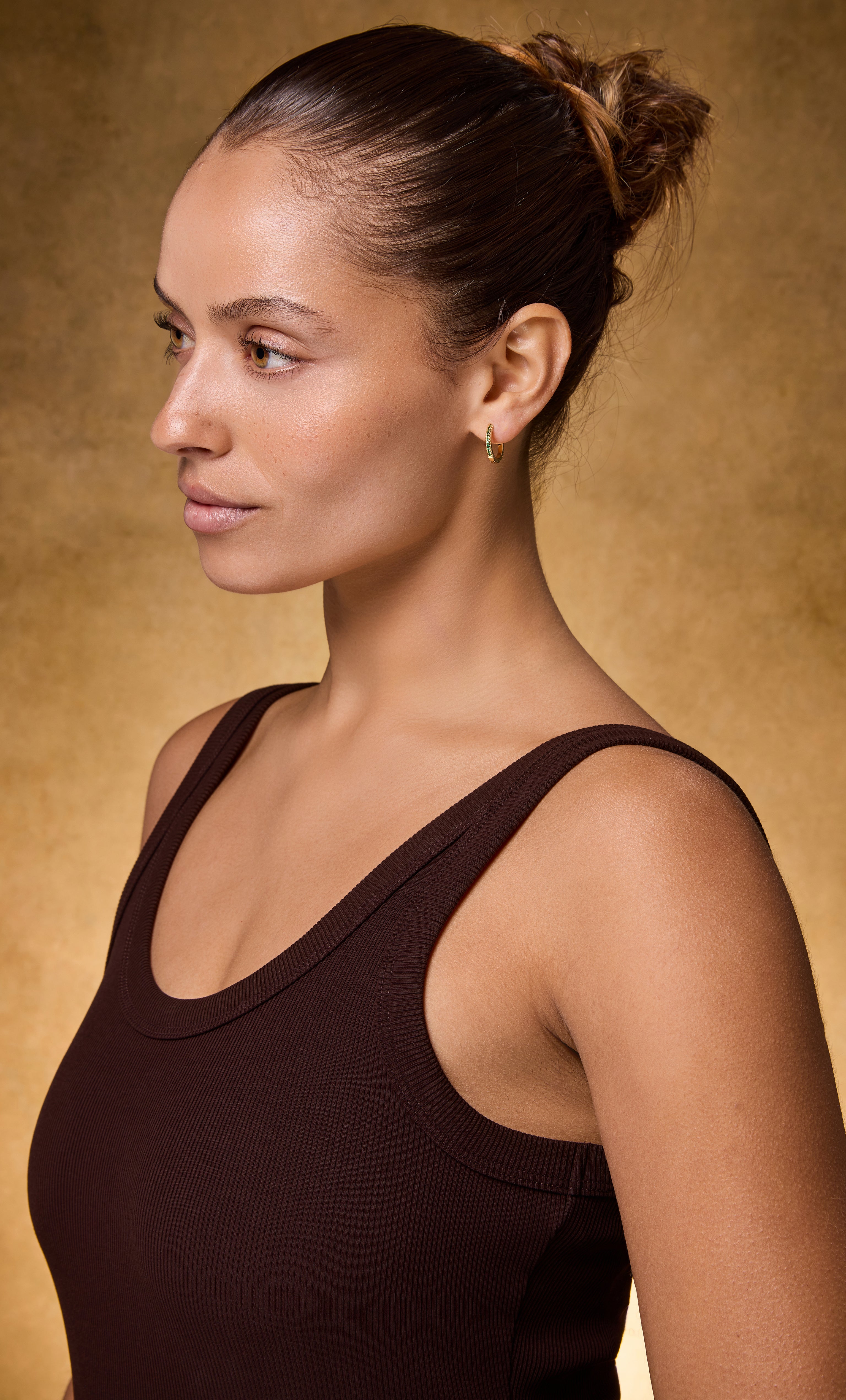 Gold fill Gaia huggie earrings with clear zirconia stones by Tunik jewellery, styled with gold necklace.