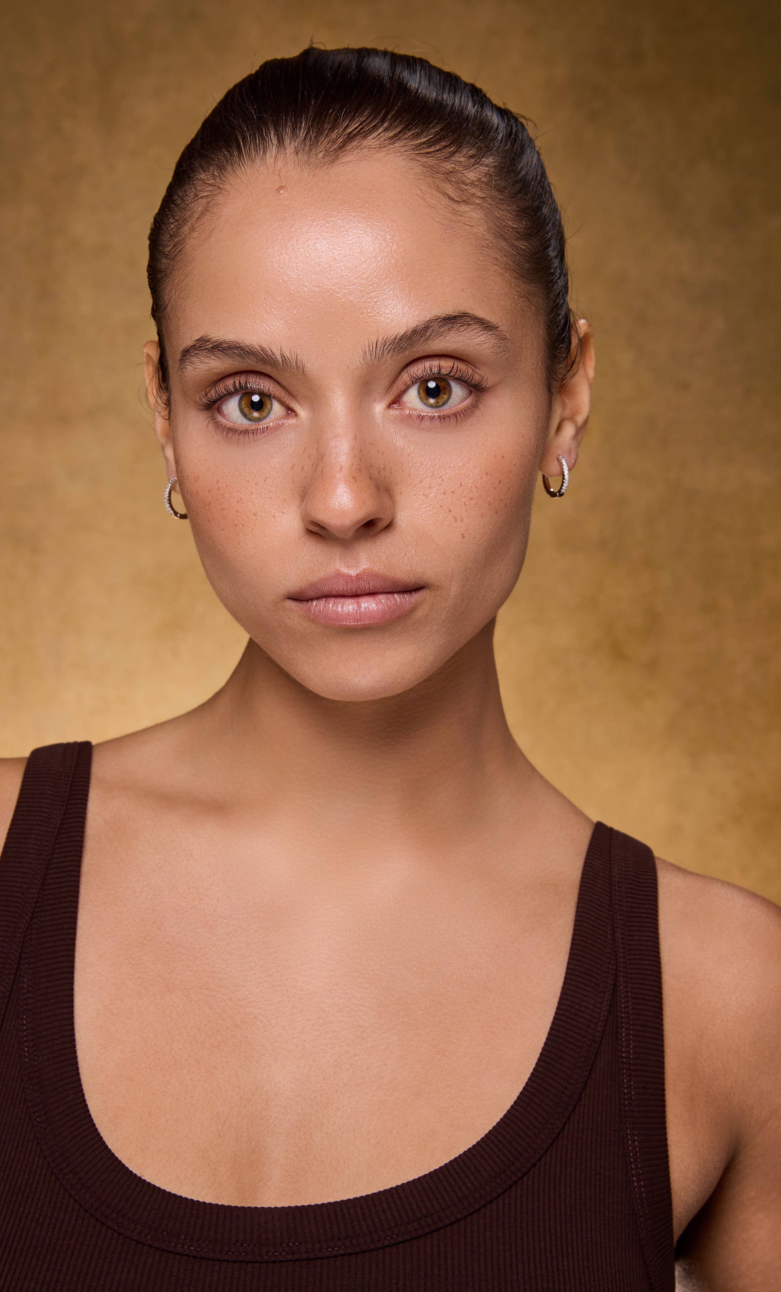 Gaia silver huggie earrings with zirconia stones, worn with gold fill necklace from Tunik jewelry gifts.