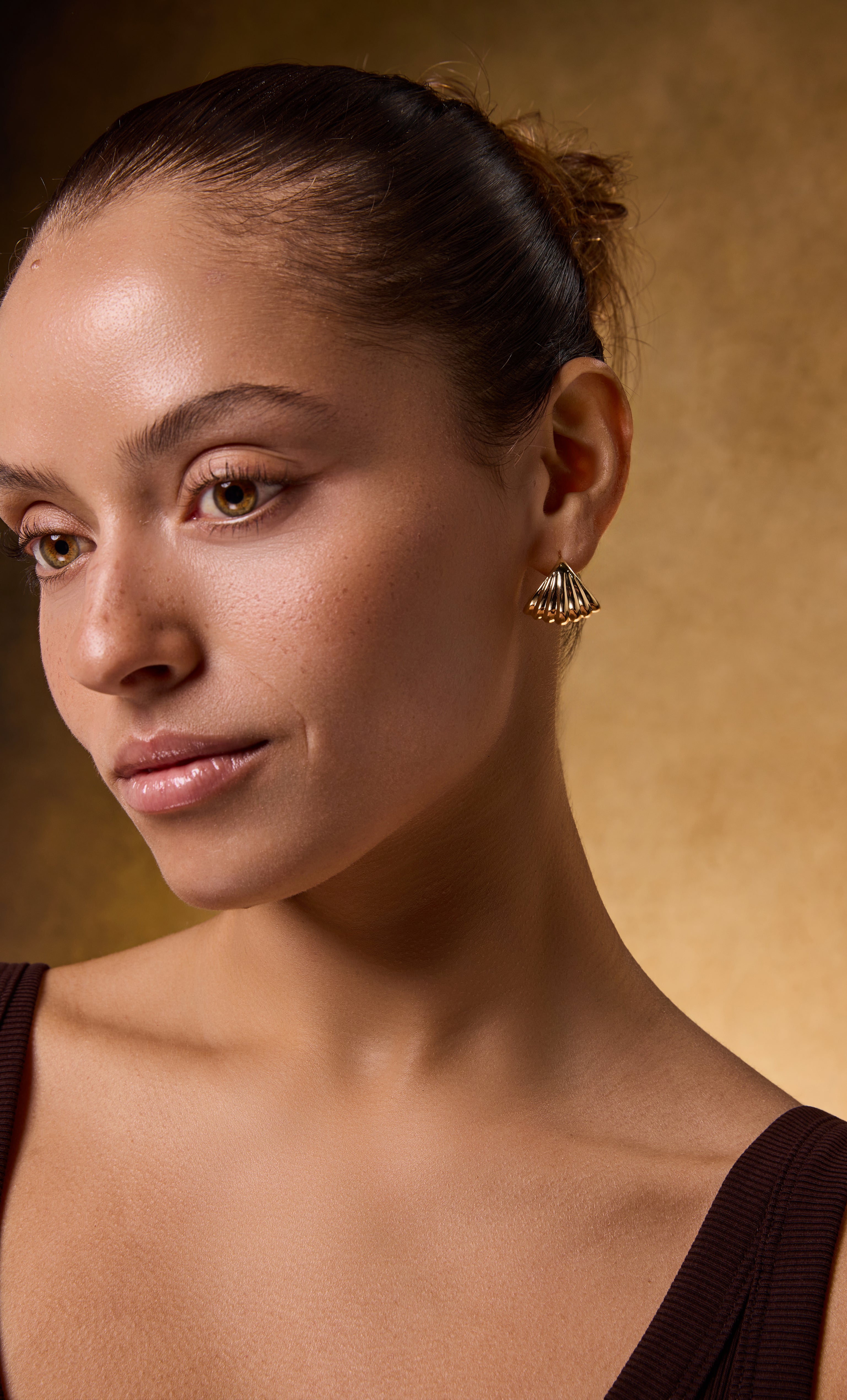 Tunik Sculpt 18K gold fill shell huggie earrings styled with gold necklace and jewellery gifts appeal.