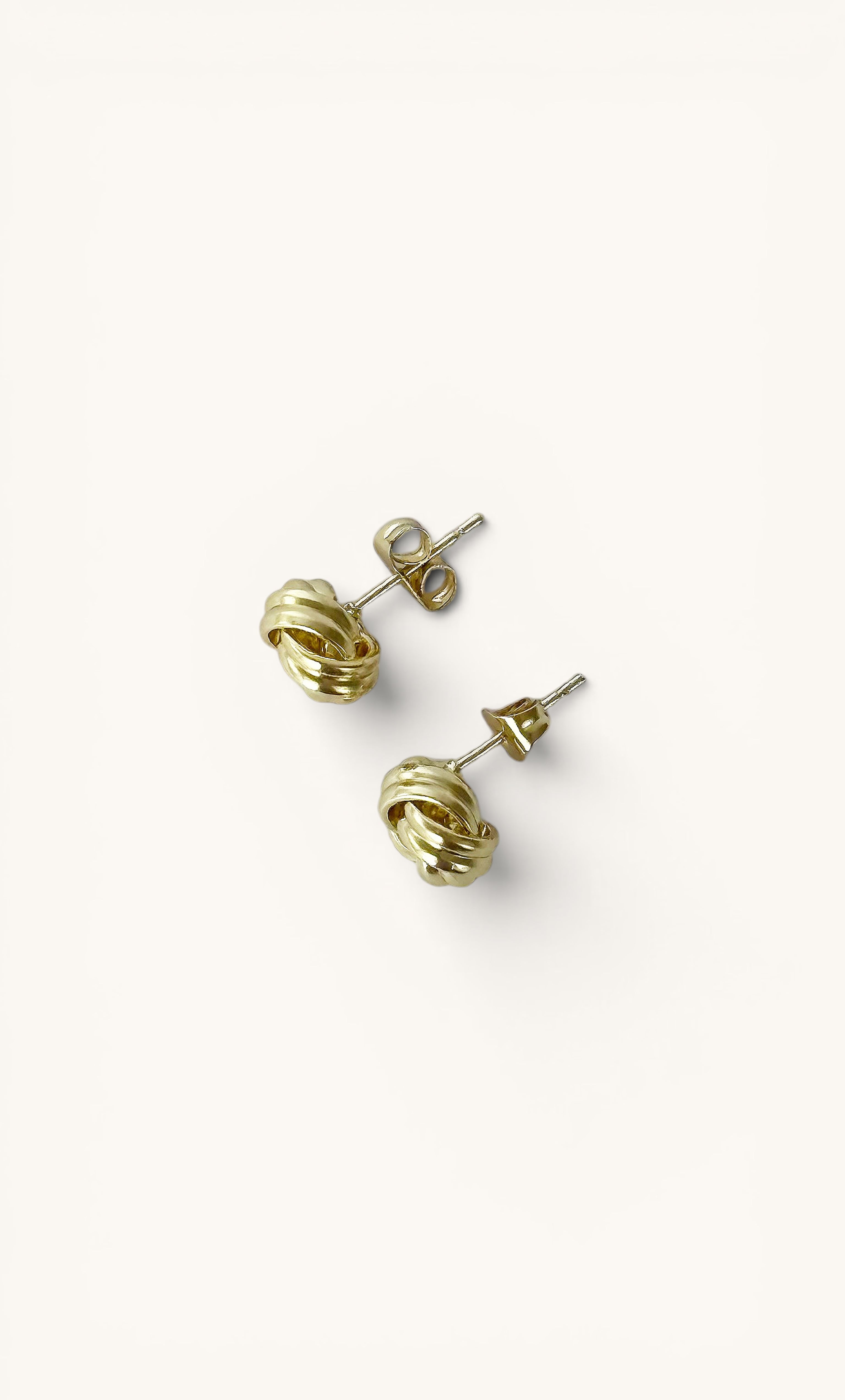 14K gold fill dainty knot stud earrings by Tunik the Label, elegant jewellery gifts.