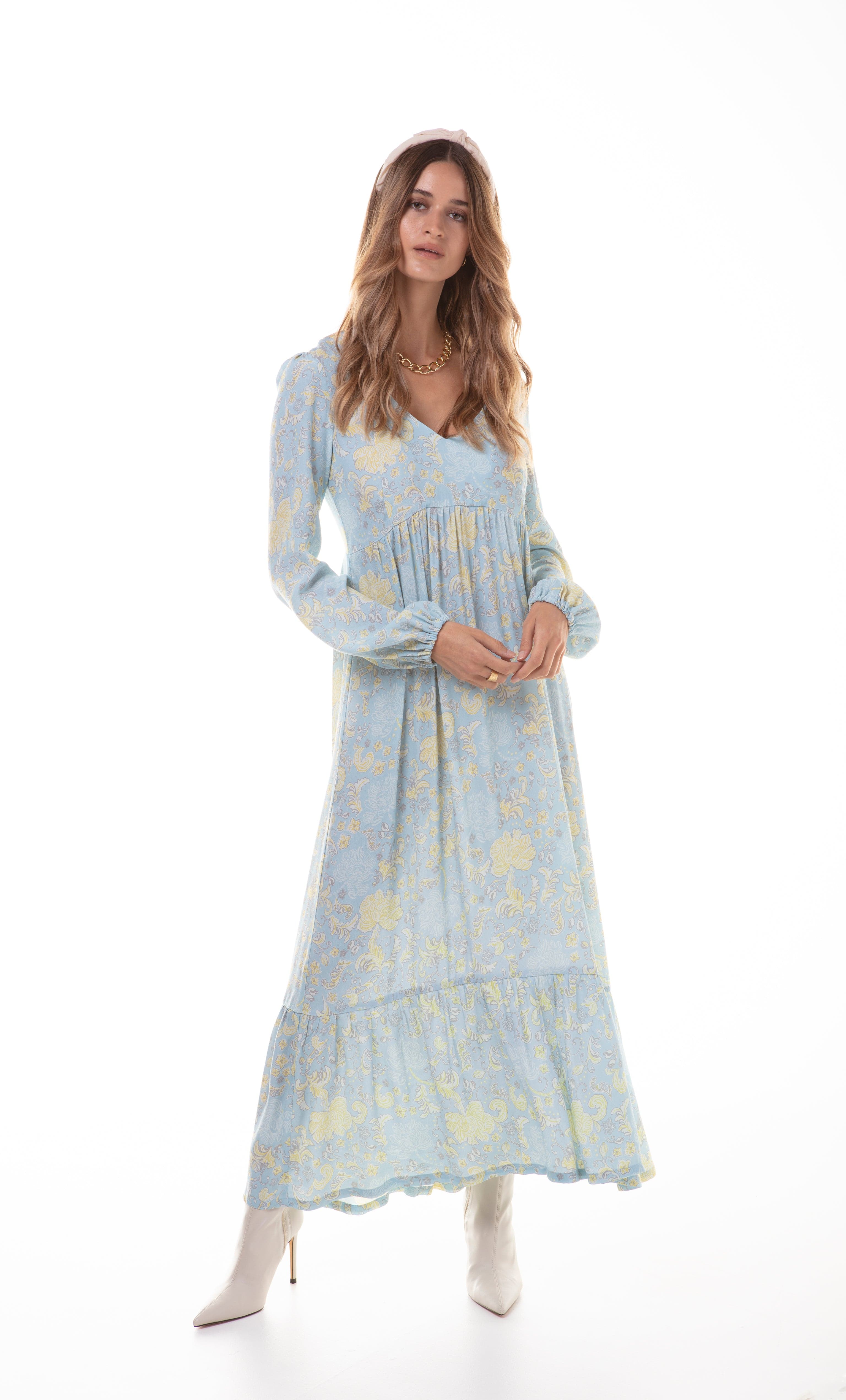 Tunik Lola maxi dress in Mystic Floral Aquamarine print with flowing empire line and long sleeves, styled with gold fill.